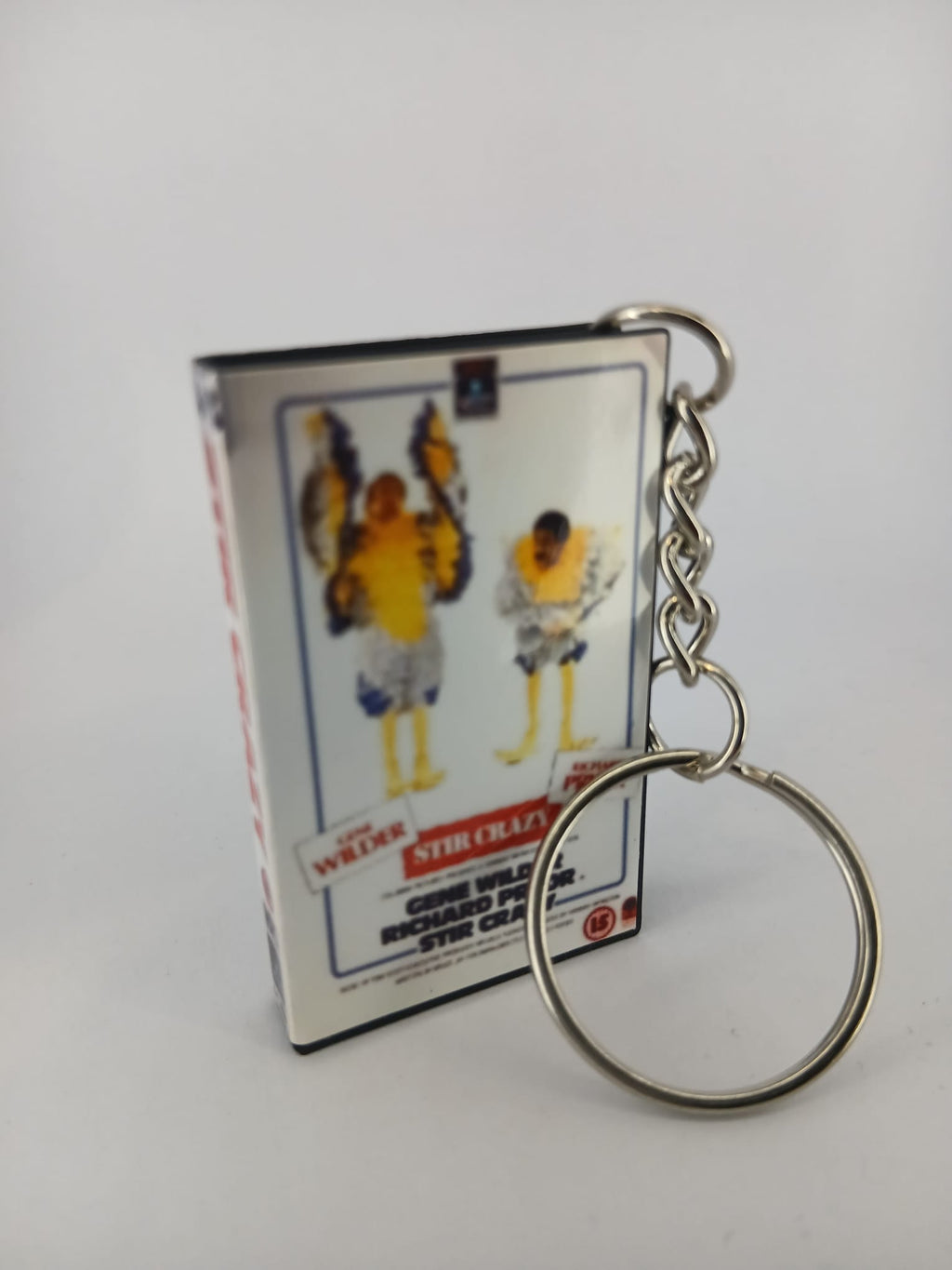 Stir Crazy VHS keyring — front cover standing angled 3