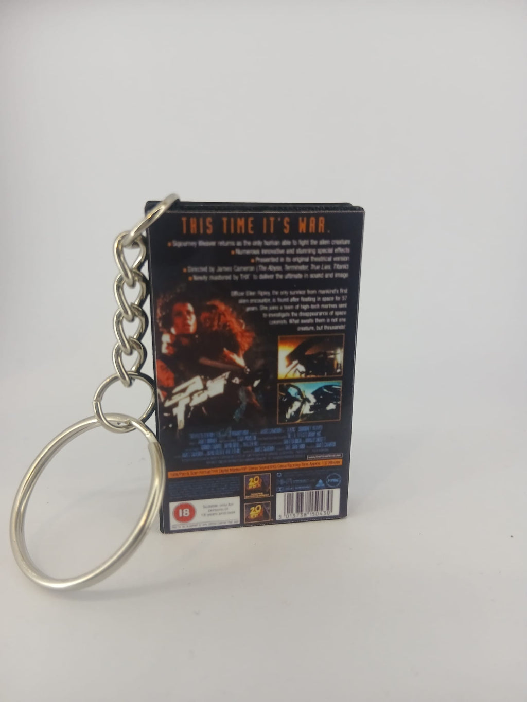 Aliens VHS keyring — spine view standing
