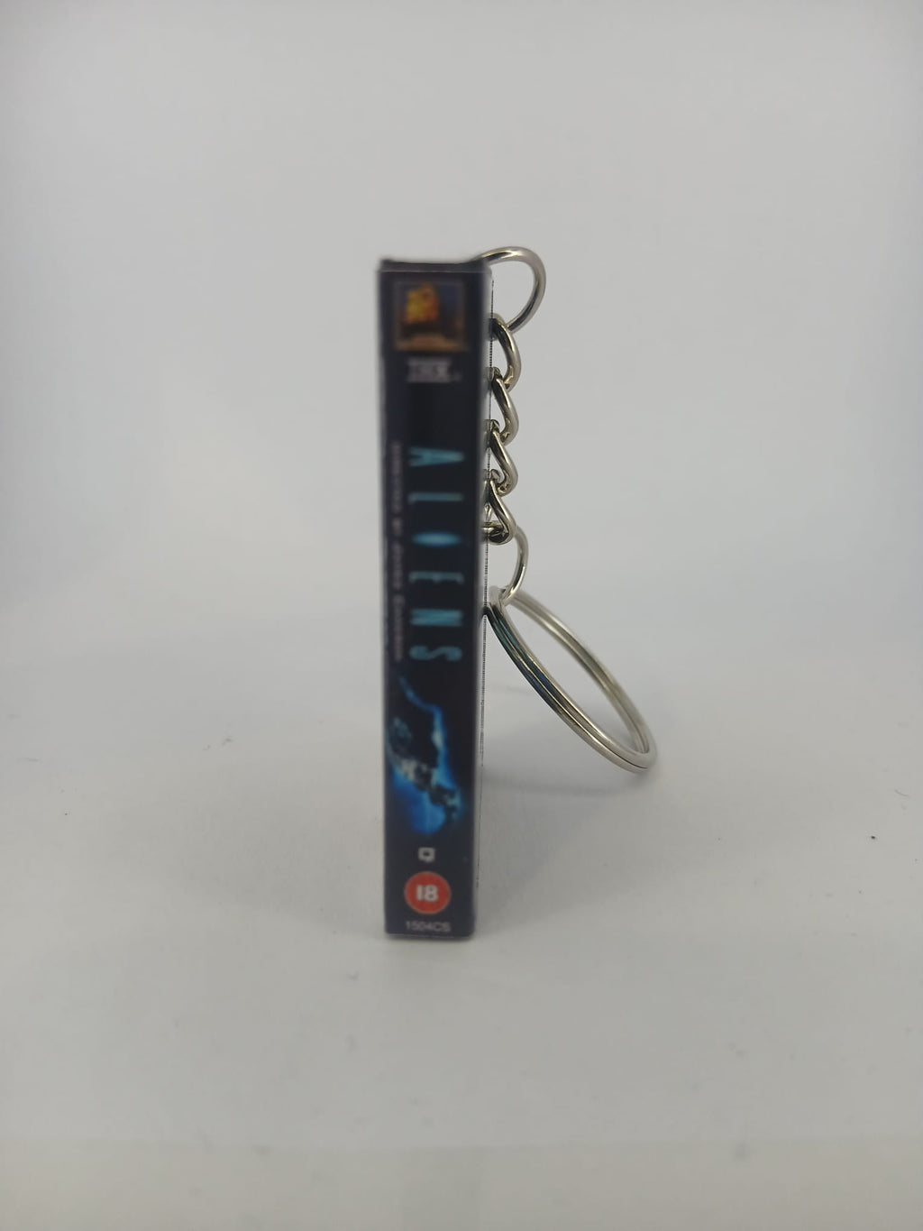 Aliens VHS keyring — front cover standing angled