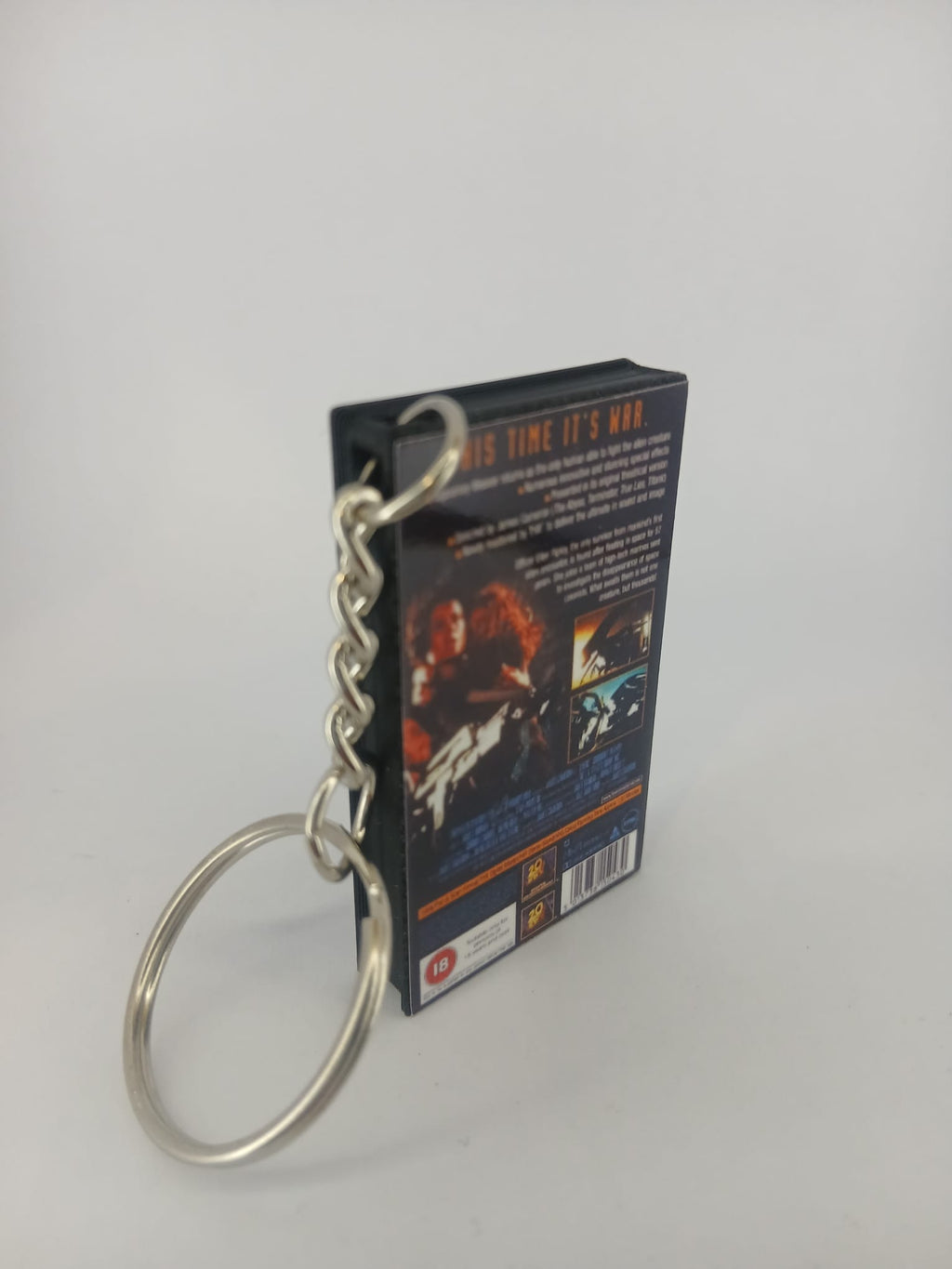 Aliens VHS keyring — back cover standing with keyring detail