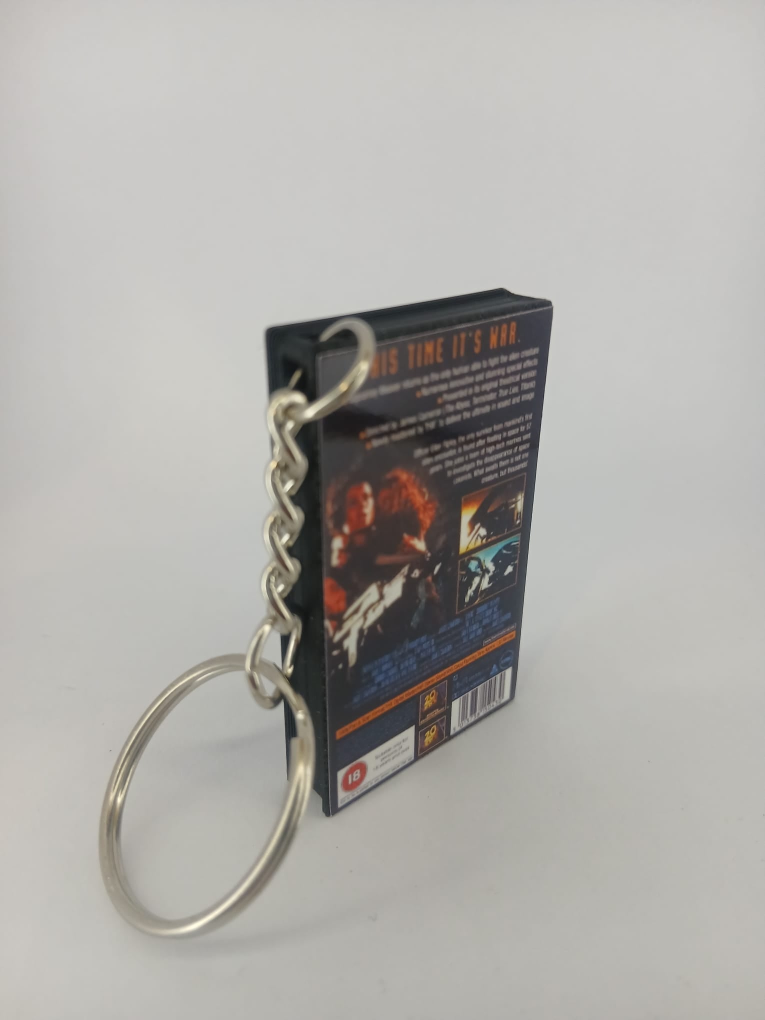 Aliens VHS keyring — back cover standing with keyring detail