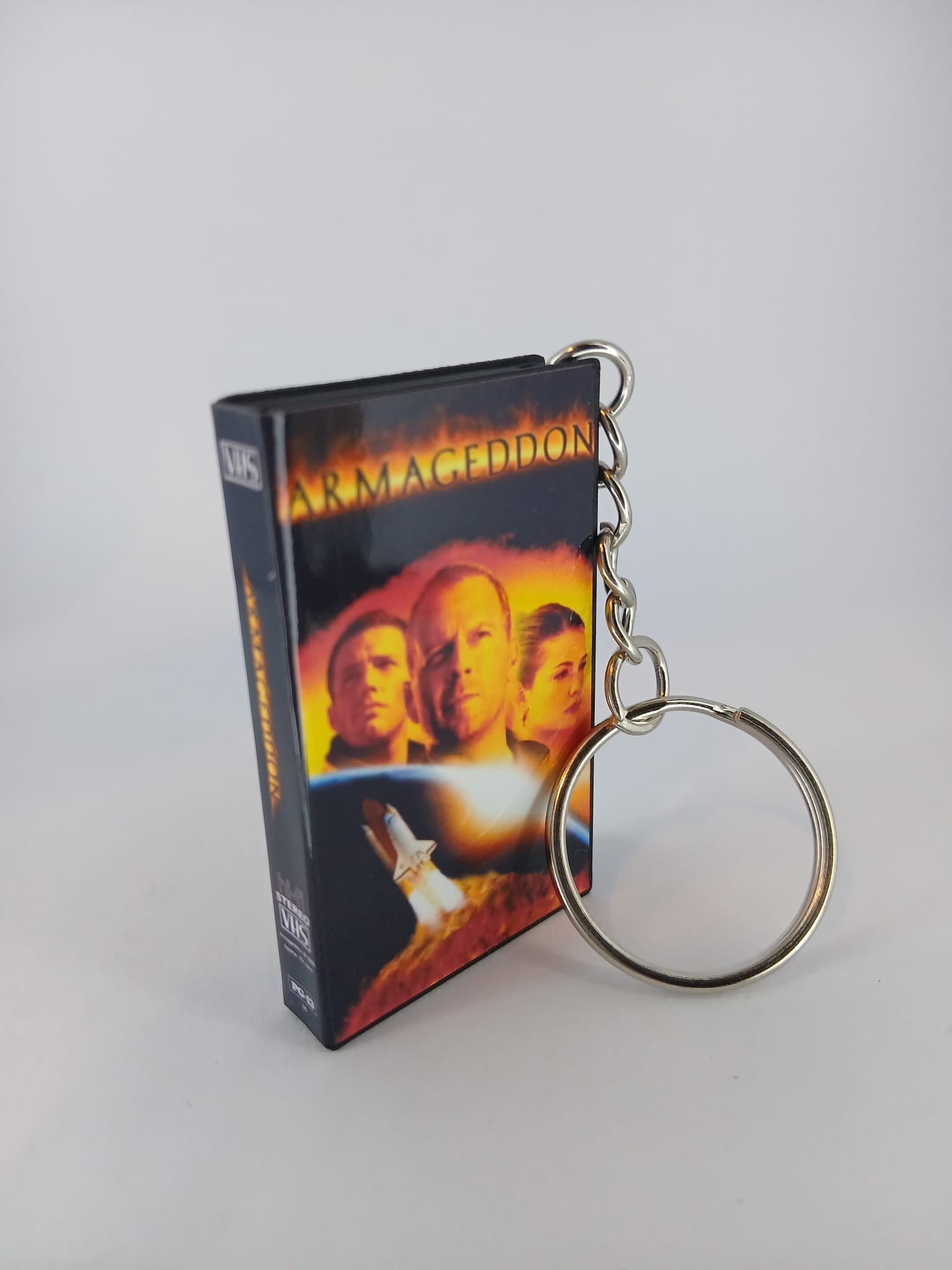 Armageddon VHS keyring — front cover flat lay angled