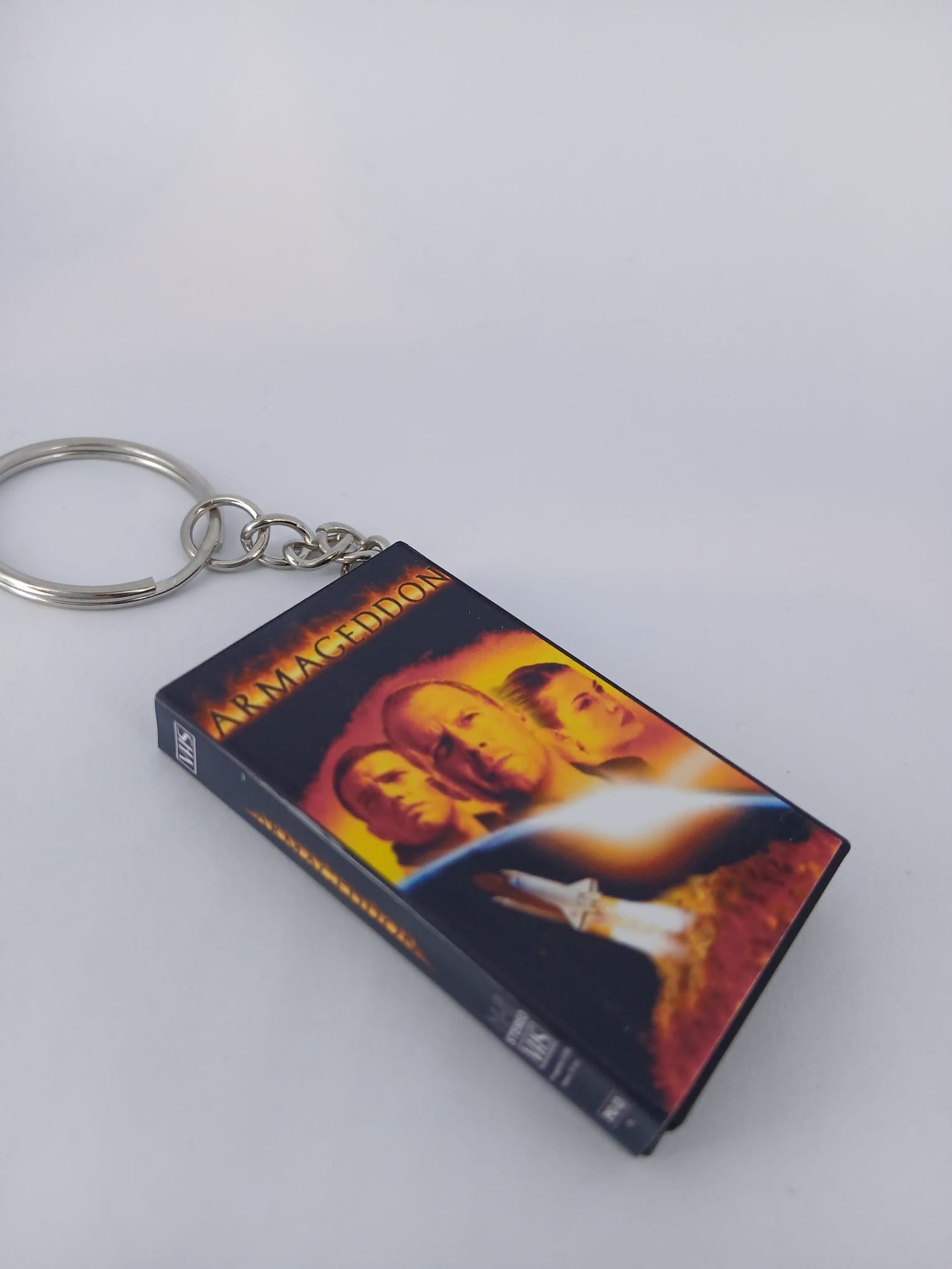 Armageddon VHS keyring — front cover standing angled