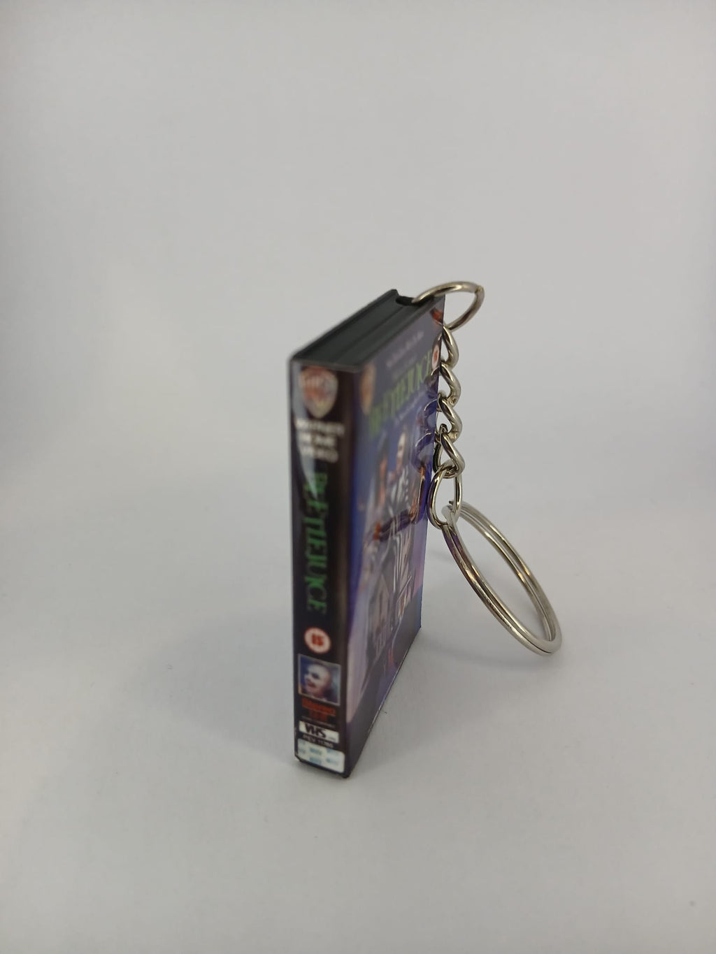 Beetlejuice VHS keyring — back cover angled view standing