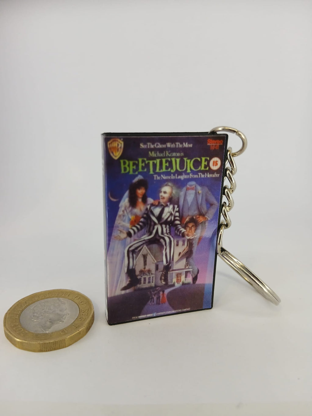 Beetlejuice VHS keyring — front and spine angled view standing