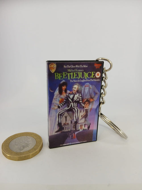 Beetlejuice VHS keyring — front and spine angled view standing