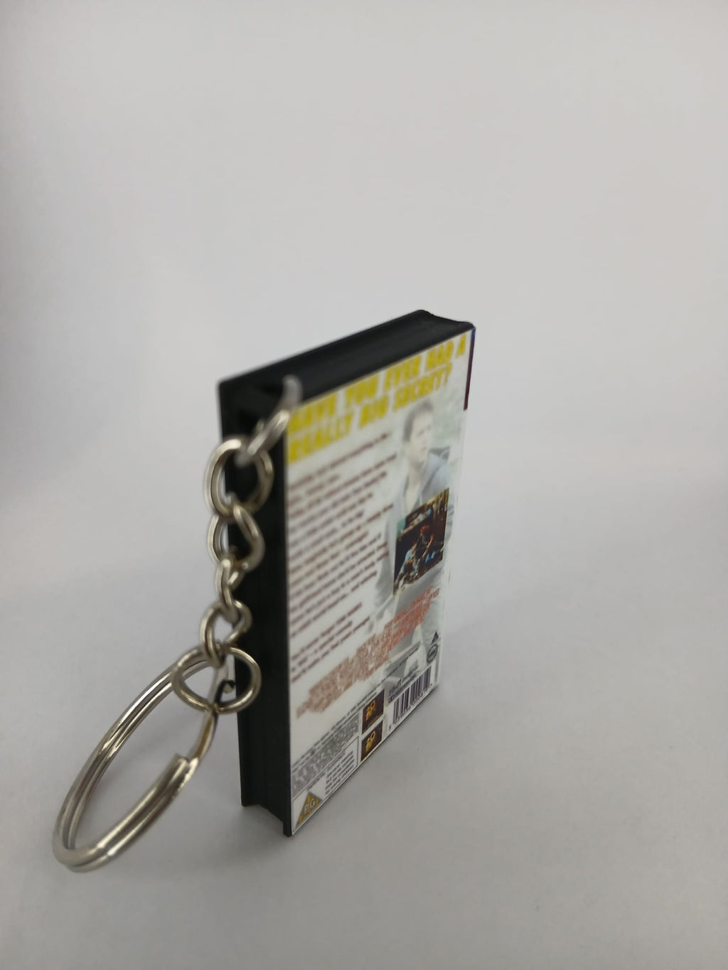 Big VHS keyring — back and spine angled view standing