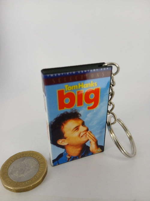Big VHS keyring — front cover standing with coin for scale