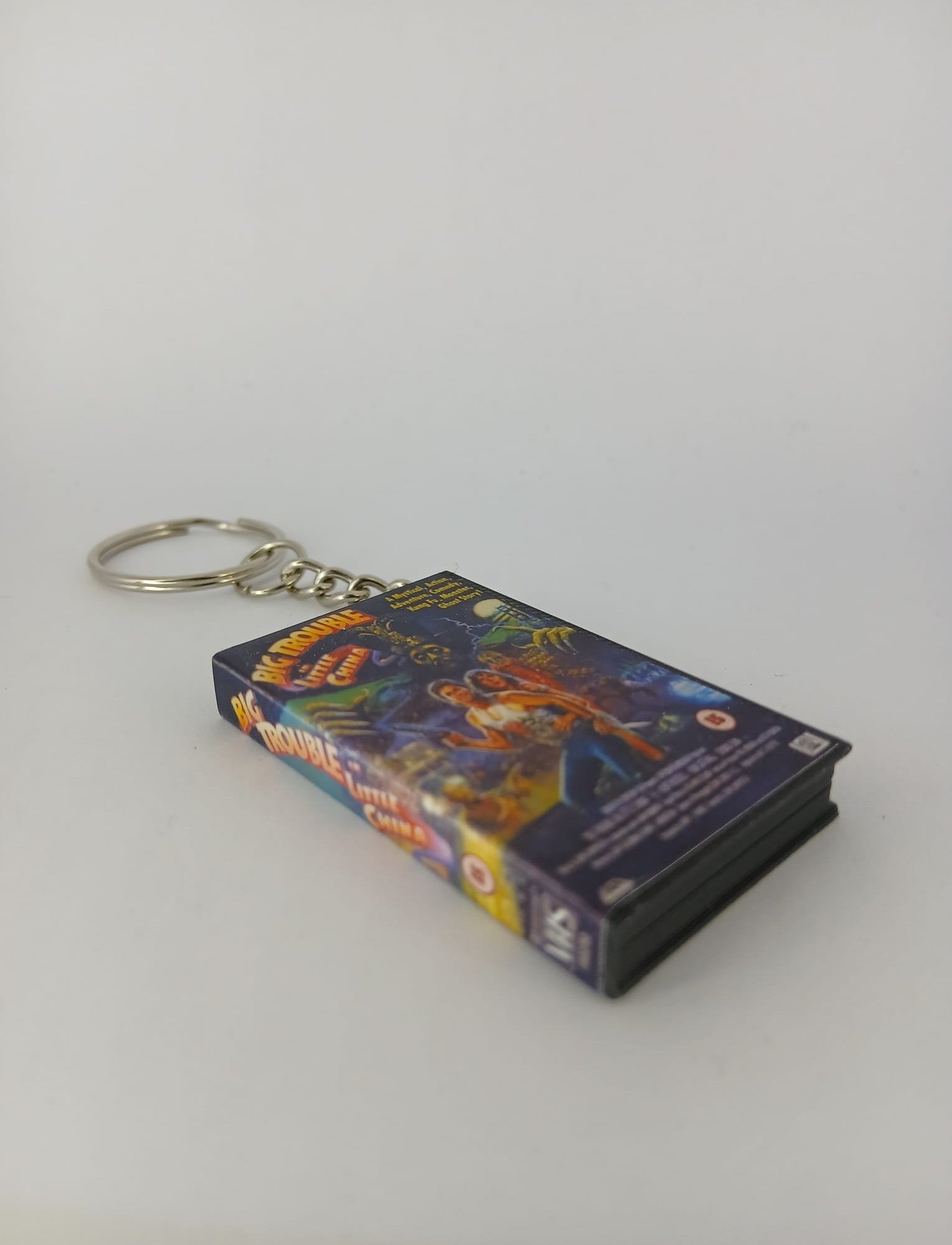 Big Trouble in Little China VHS keyring — flat lay overhead showing full wrap