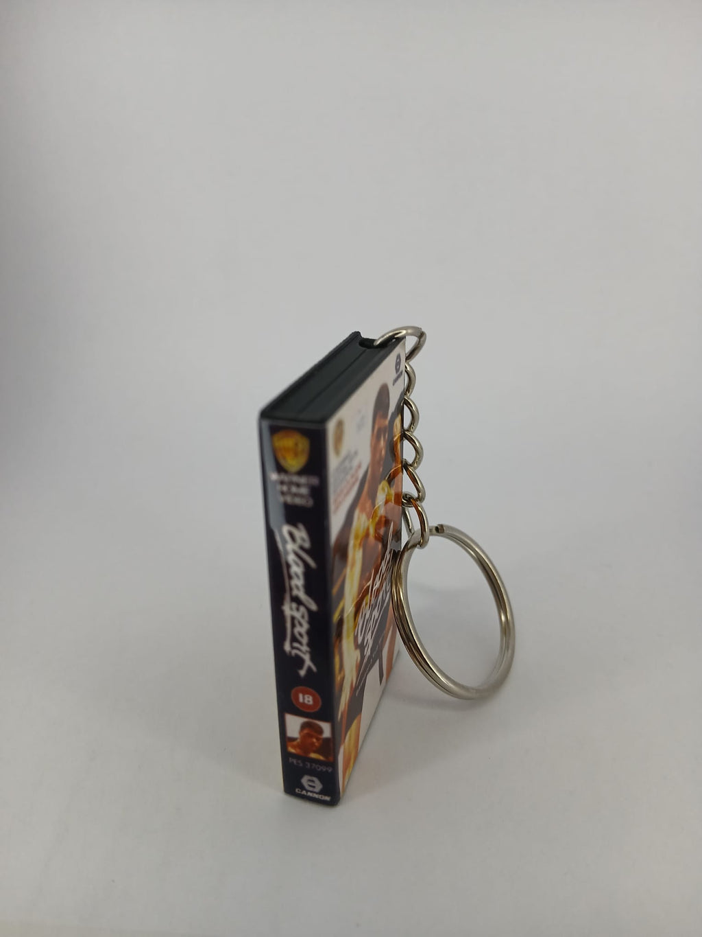 Bloodsport VHS keyring — front cover standing angled