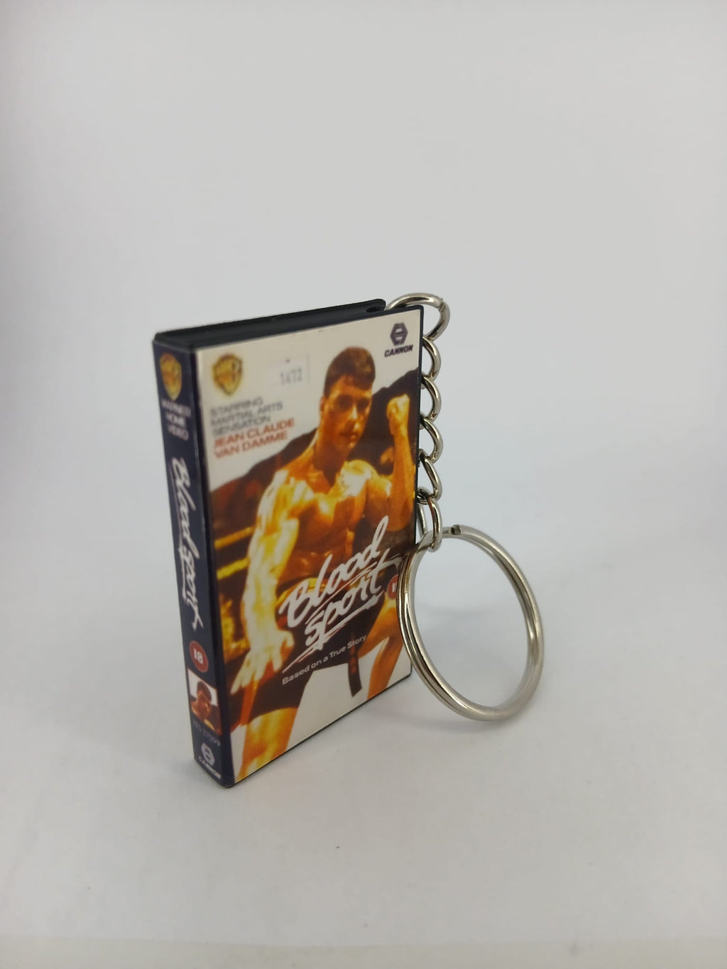 Bloodsport VHS keyring — front cover standing angled 2