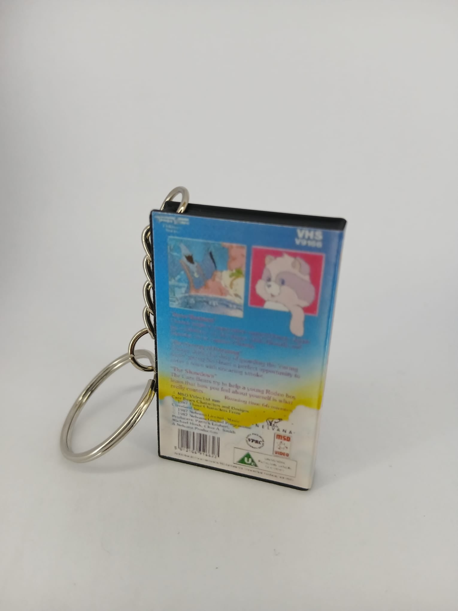 Care Bears VHS keyring — front cover flat lay angled
