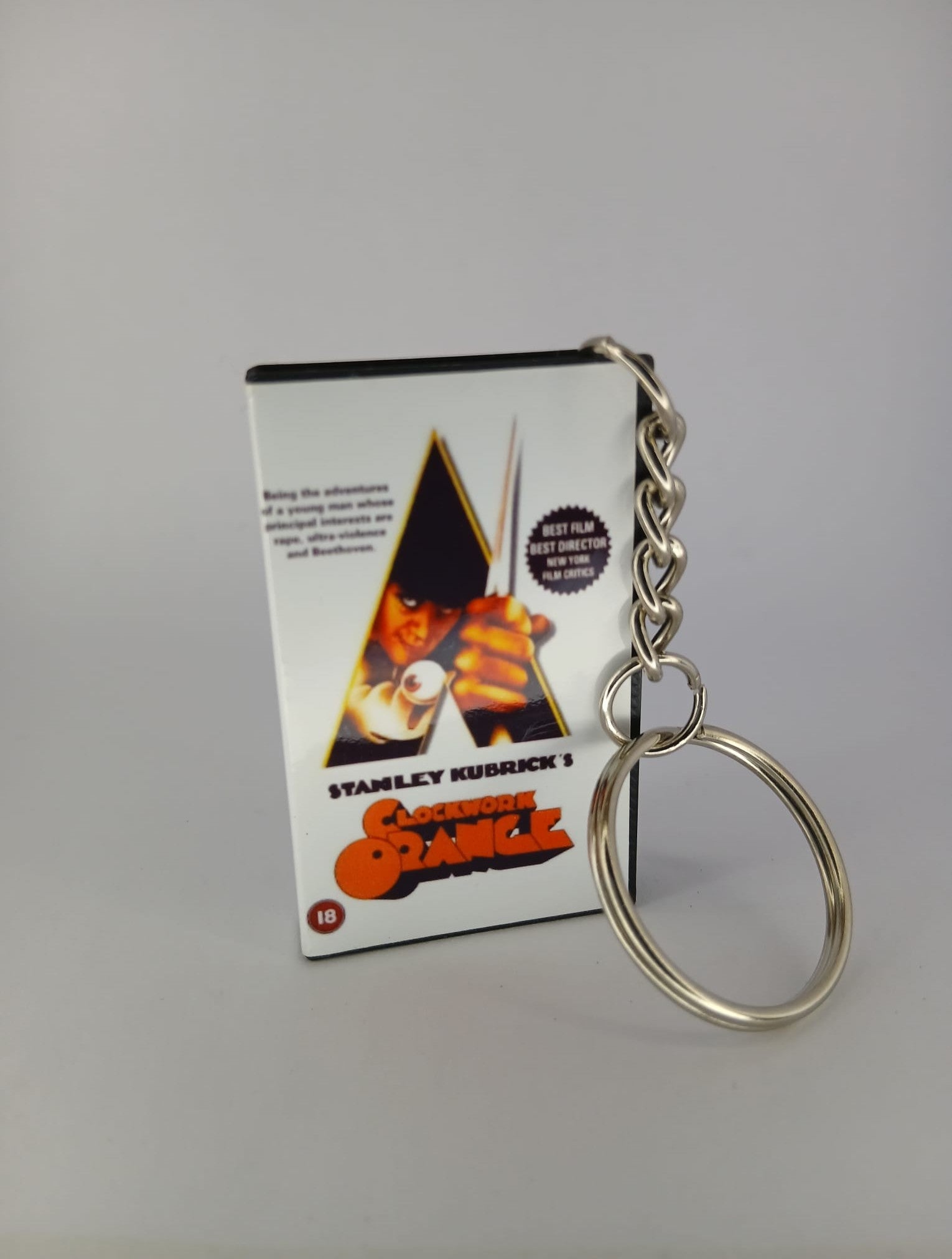A Clockwork Orange VHS keyring — front cover standing angled