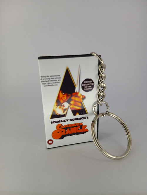 A Clockwork Orange VHS keyring — front cover standing angled