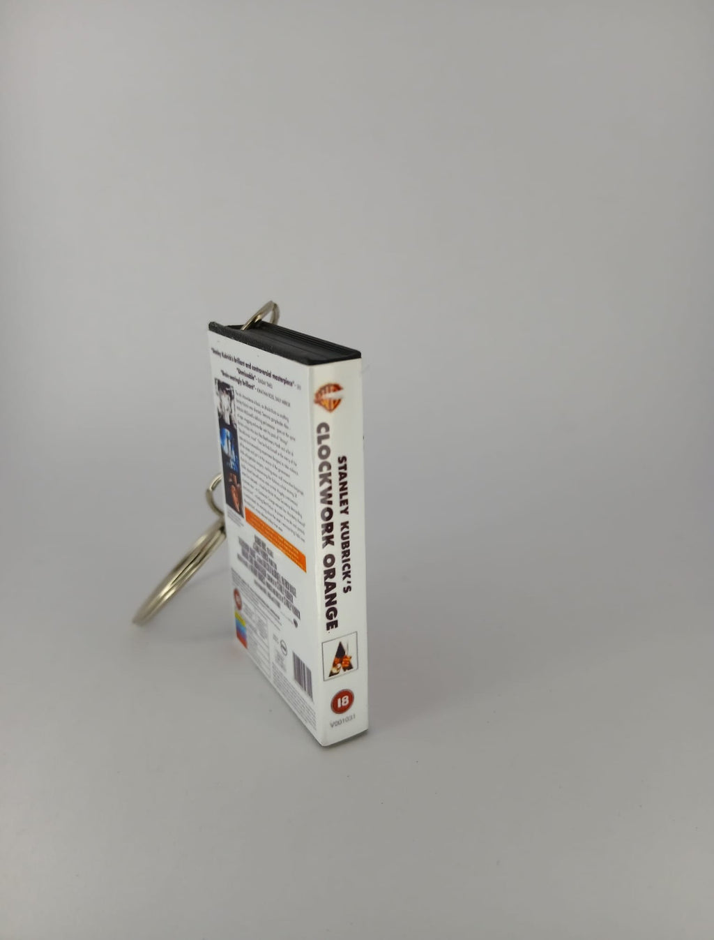 A Clockwork Orange VHS keyring — front and spine angled view standing