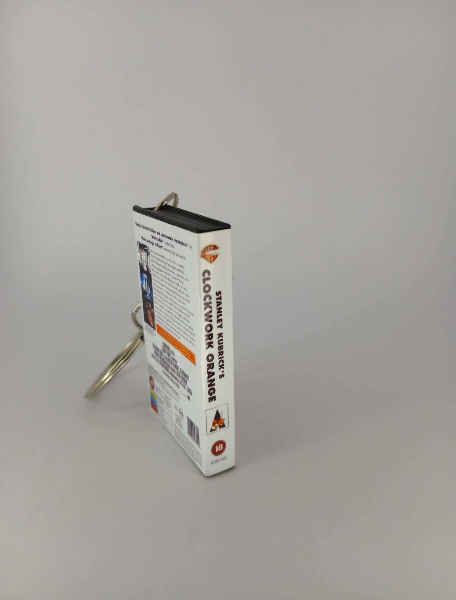 A Clockwork Orange VHS keyring — front and spine angled view standing