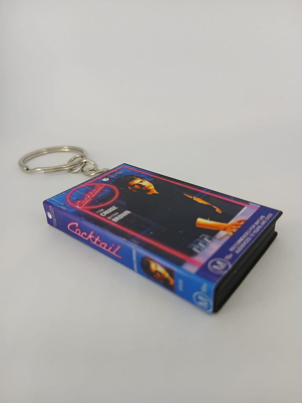 Cocktail VHS keyring — front cover flat lay angled