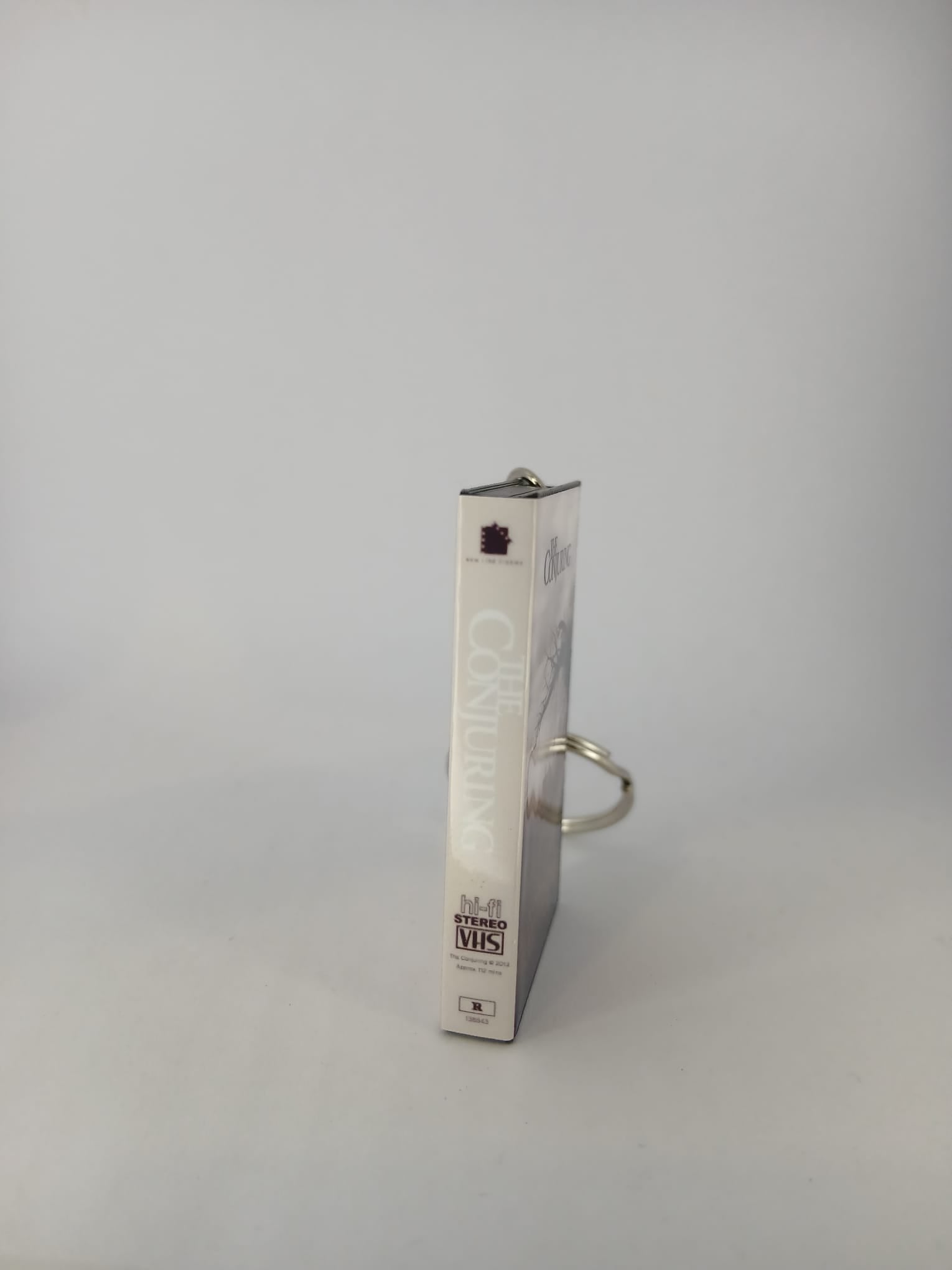 The Conjuring VHS keyring — spine view