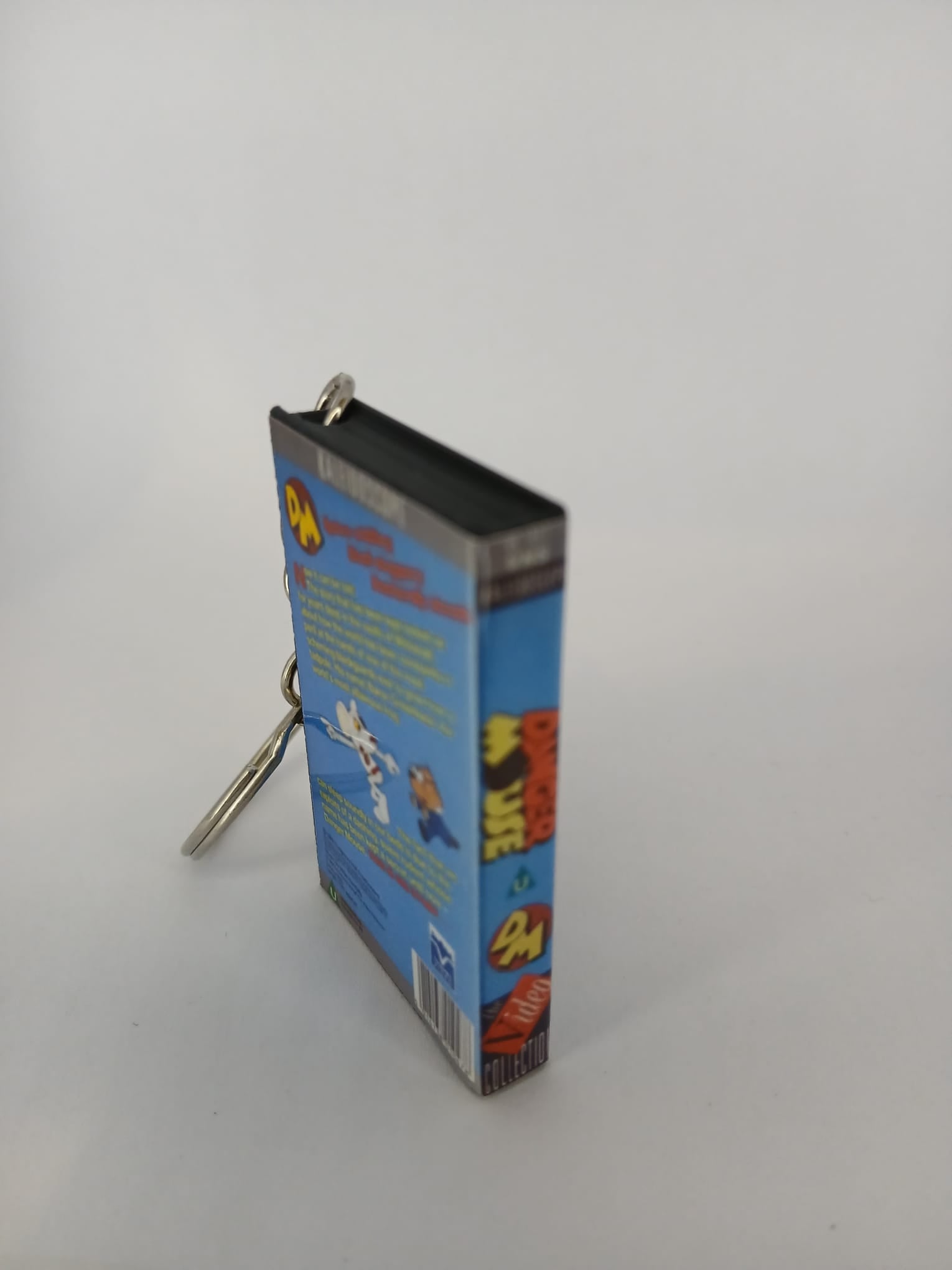 Danger Mouse VHS keyring — front and spine angled view standing