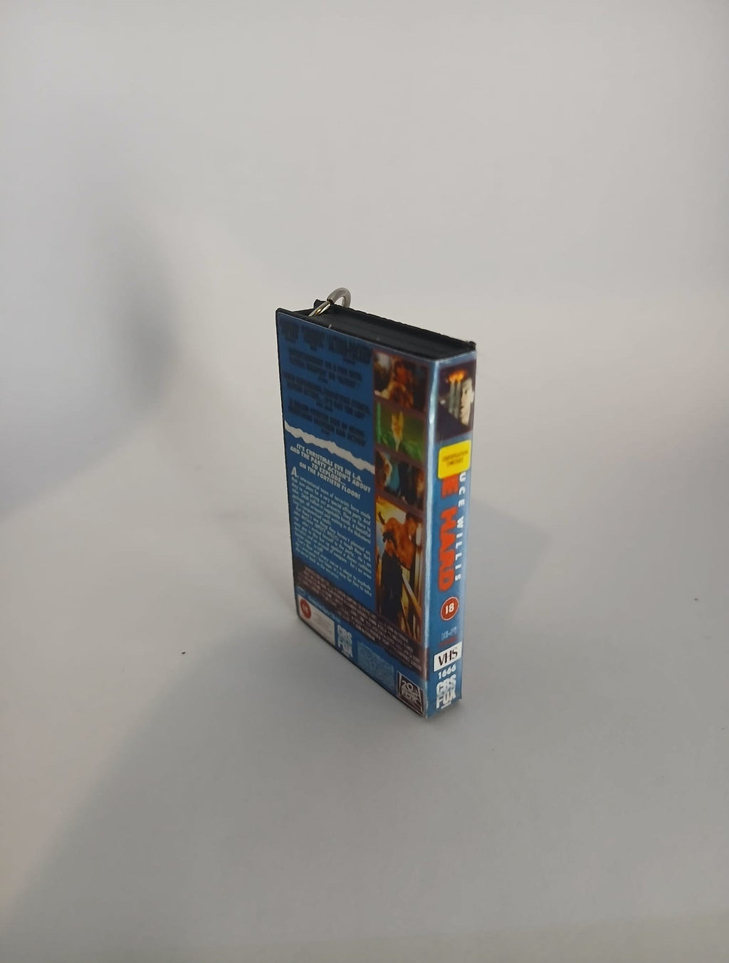 Die Hard VHS keyring — back cover angled view standing