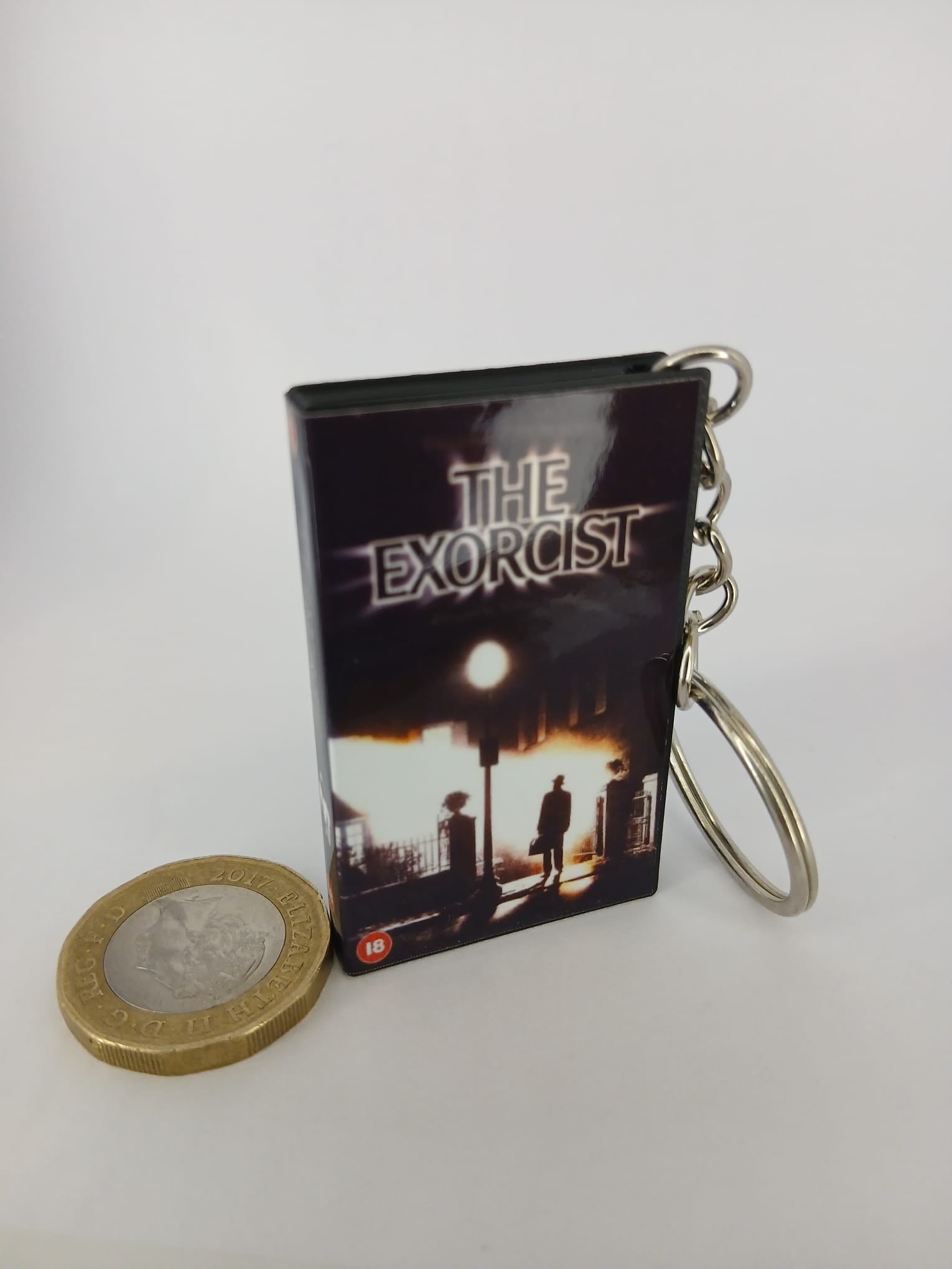 The Exorcist VHS keyring — flat lay front and spine angled