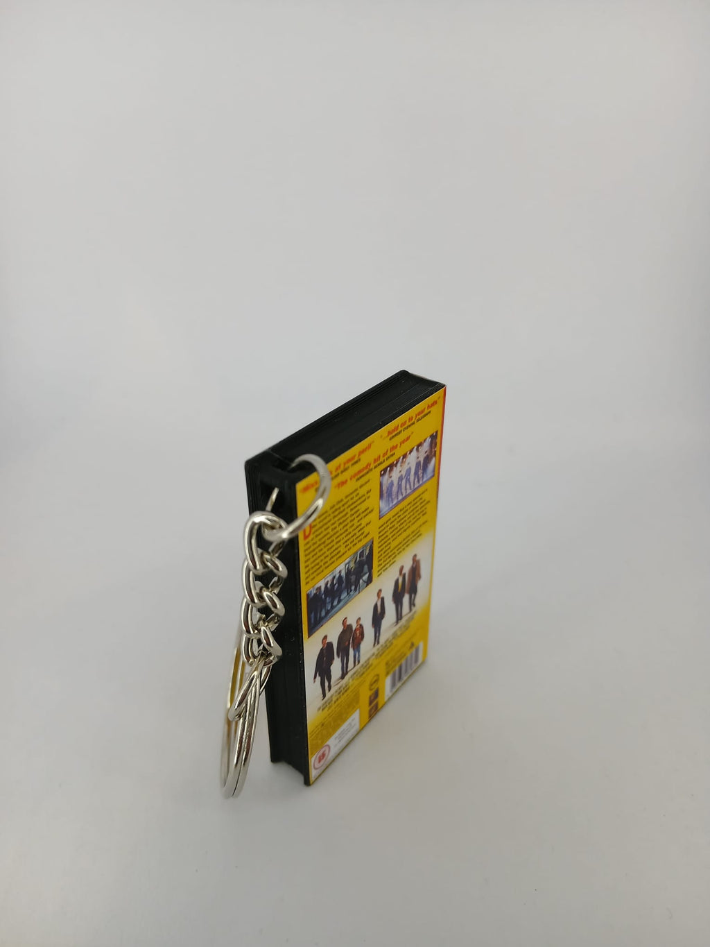 The Full Monty VHS keyring — back cover angled view standing