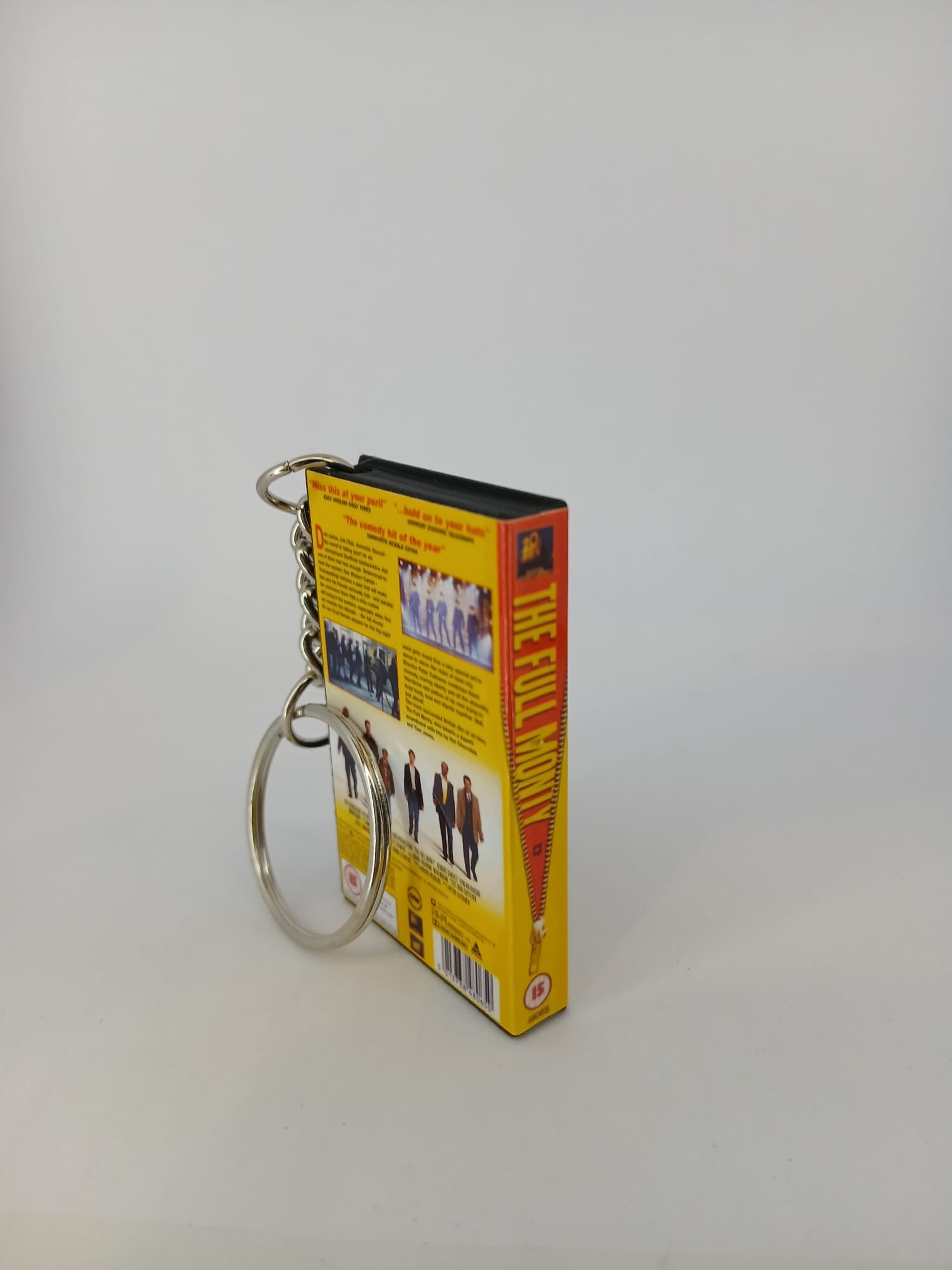 The Full Monty VHS keyring — spine view standing