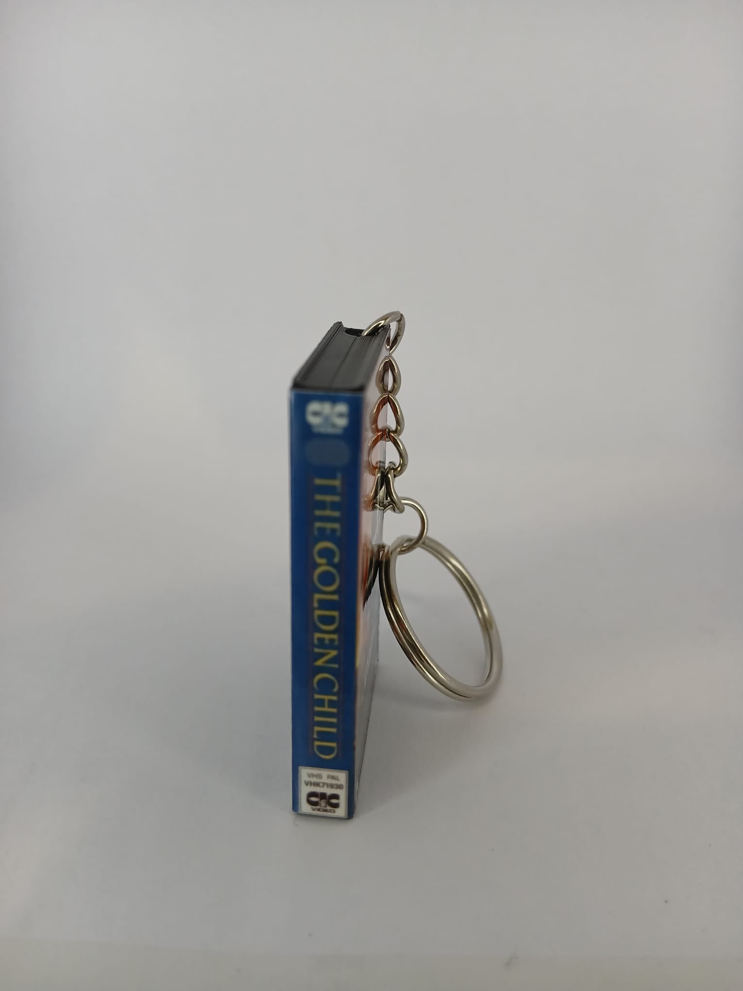 The Golden Child VHS keyring — back cover angled view standing