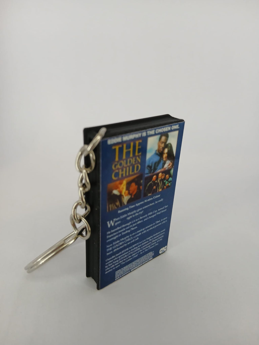 The Golden Child VHS keyring — back and spine angled view standing