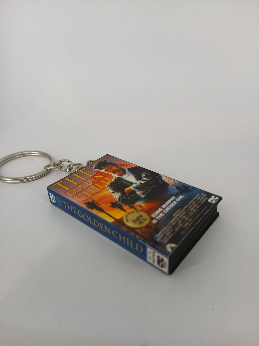 The Golden Child VHS keyring — front cover standing angled