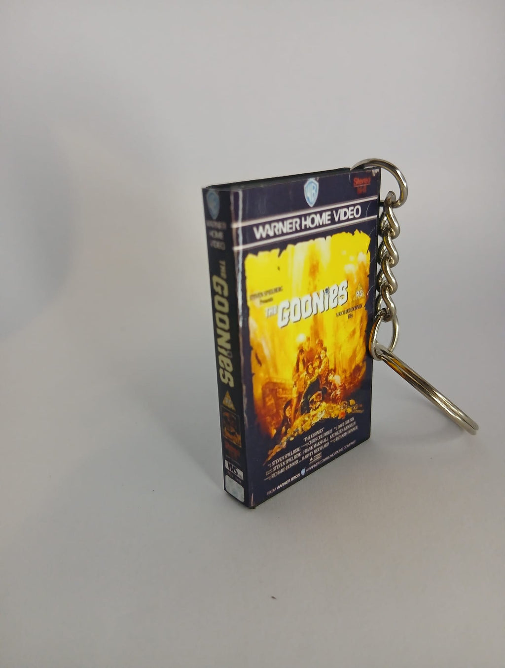 The Goonies VHS keyring — back and spine angled view standing