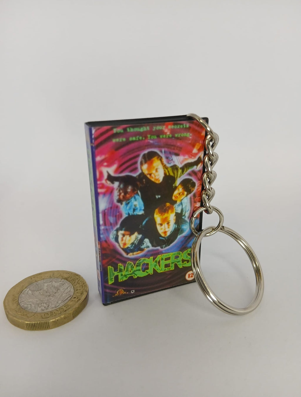 Hackers VHS keyring — front and spine angled view standing