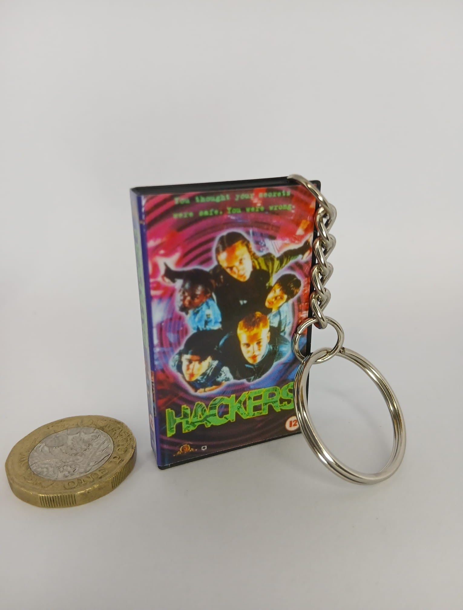 Hackers VHS keyring — front and spine angled view standing