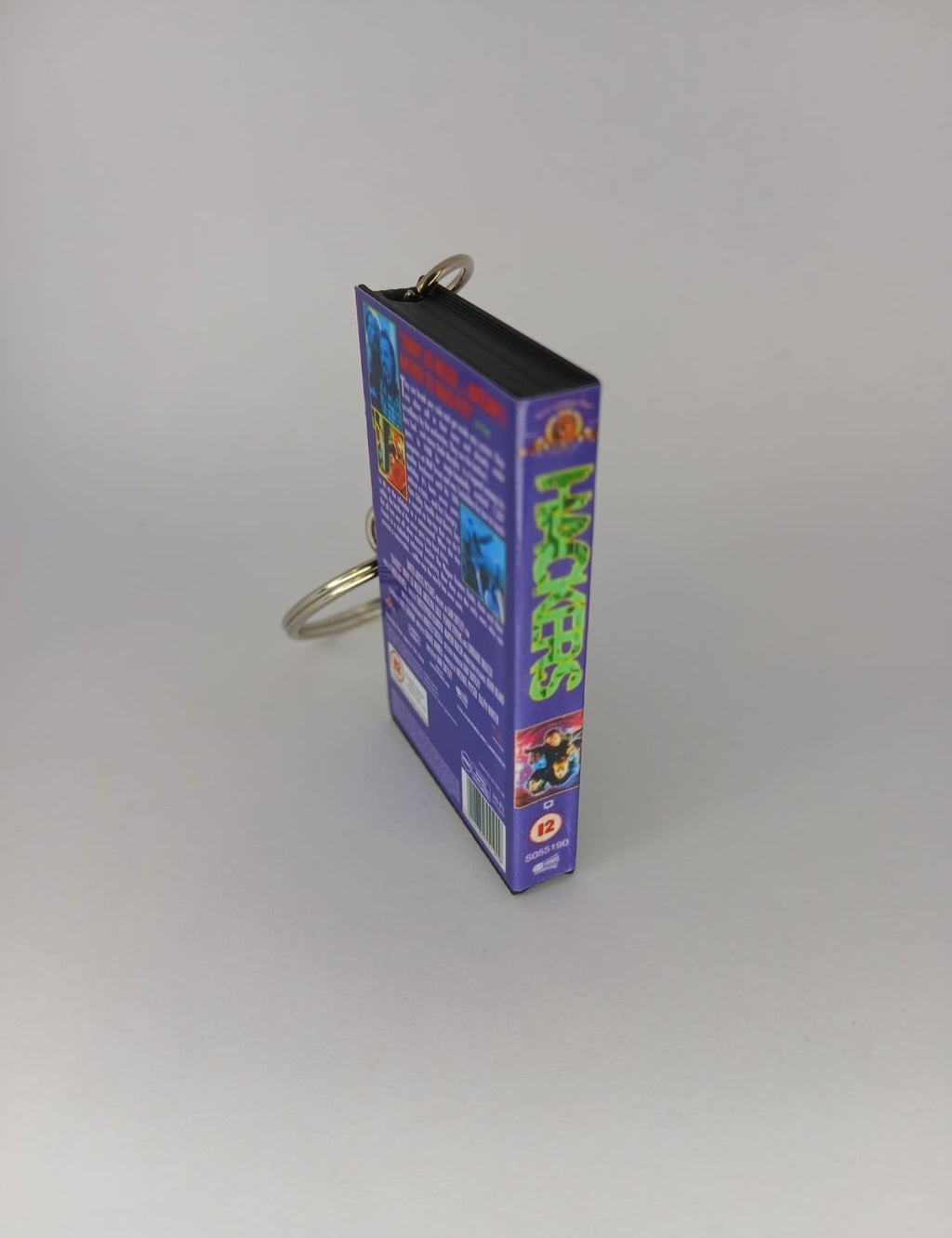 Hackers VHS keyring — flat lay front and spine angled