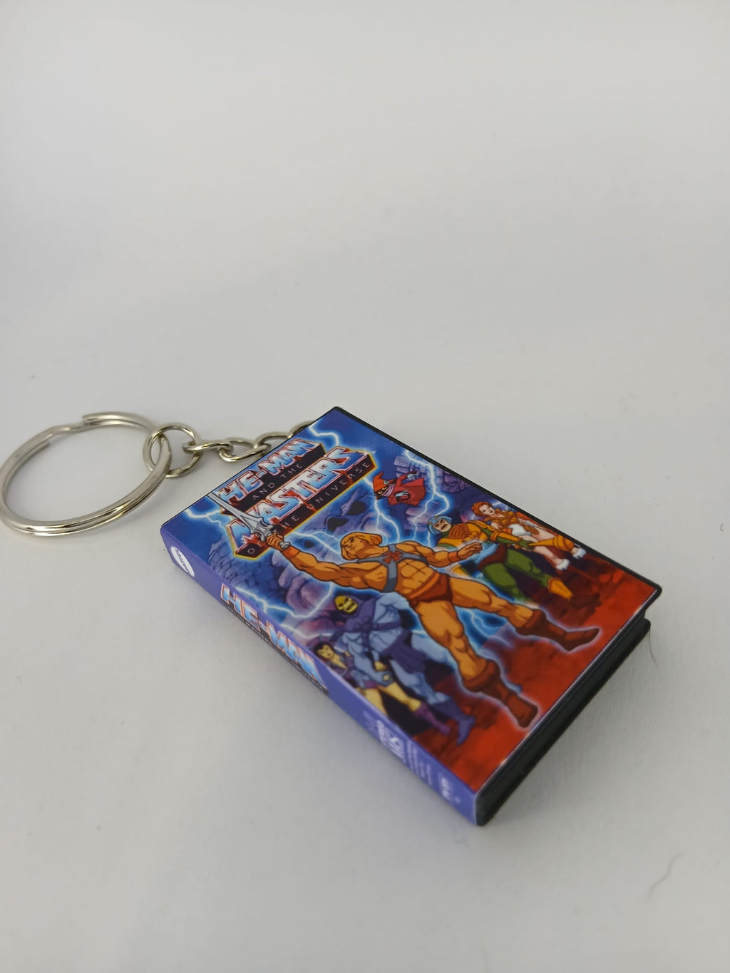 He-Man VHS keyring flat lay