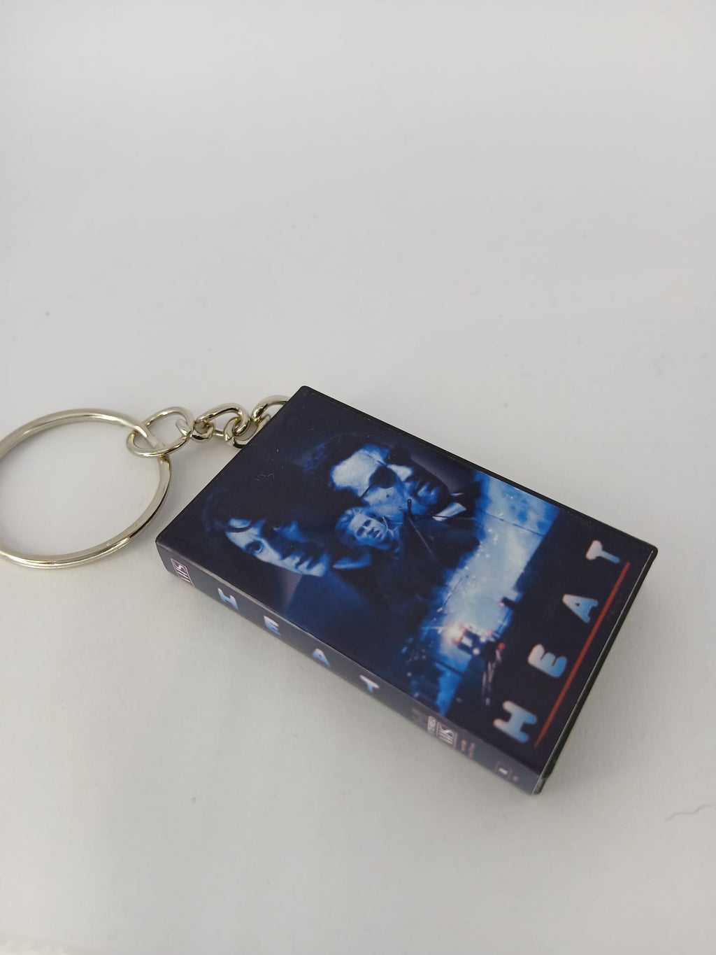 Heat VHS keyring flat lay with coin for scale