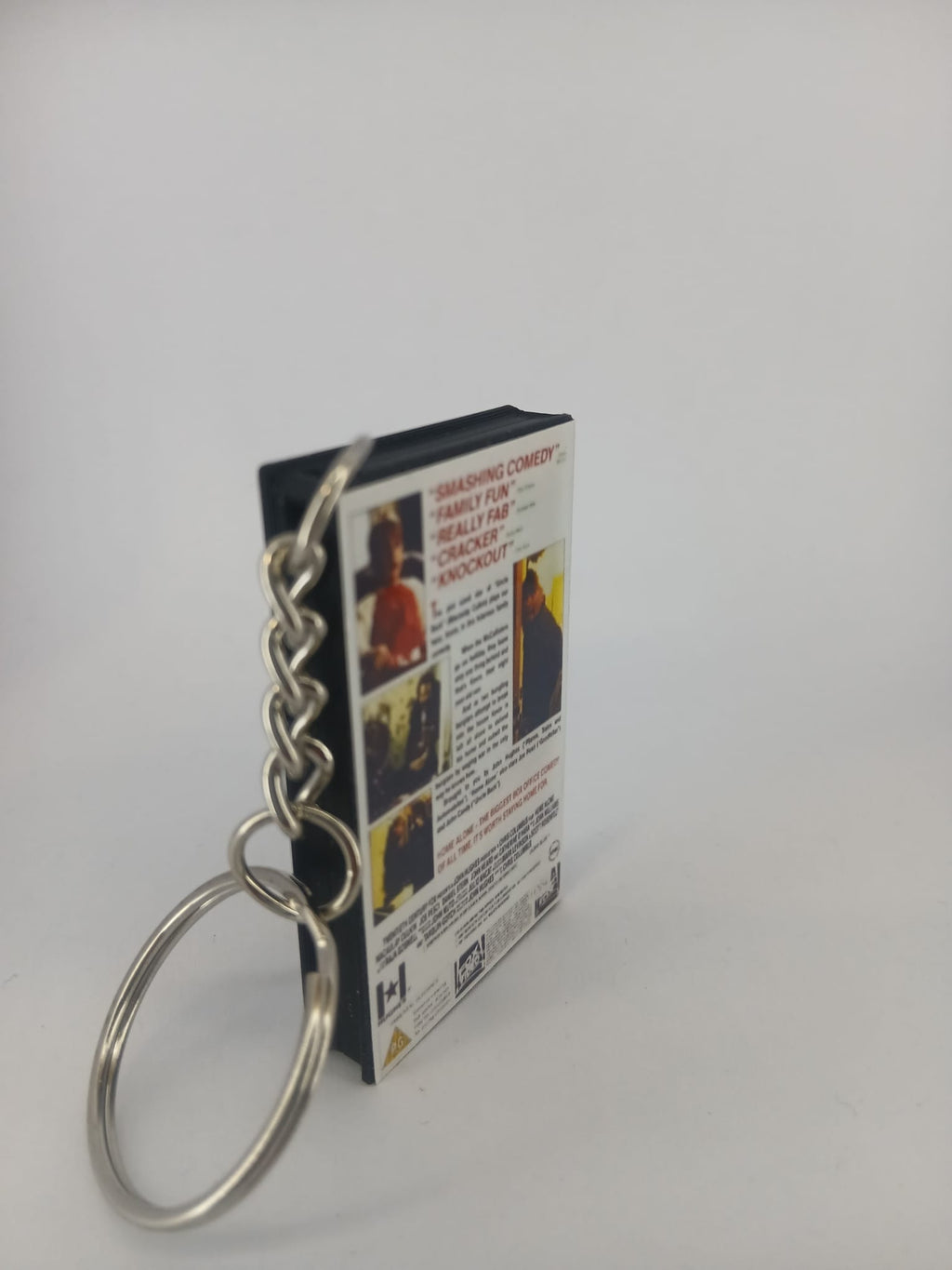 Home Alone VHS keyring — flat lay front and spine angled