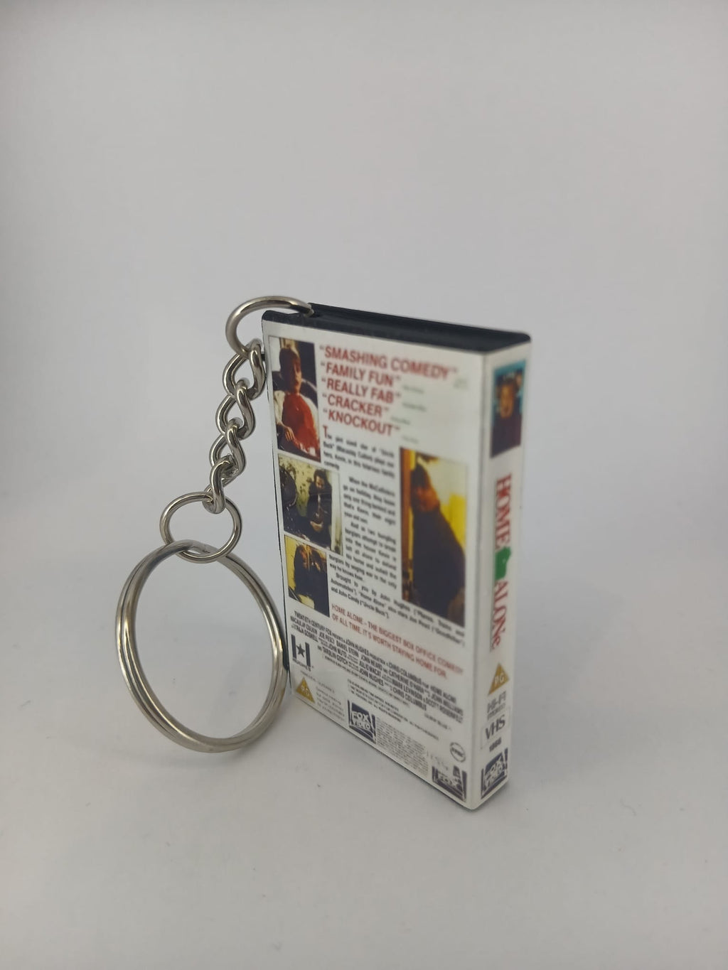 Home Alone VHS keyring — front cover standing angled with keyring detail