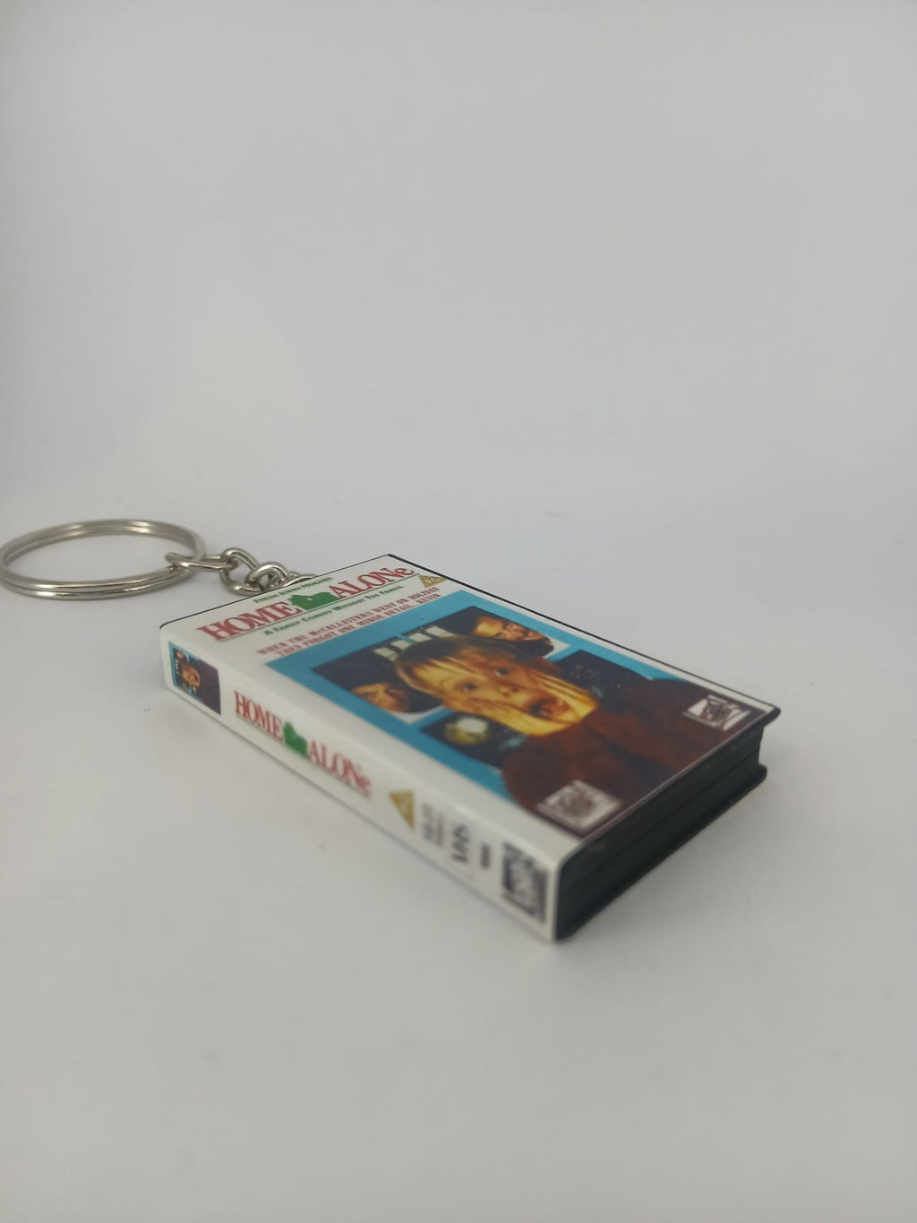 Home Alone VHS keyring — front cover standing angled