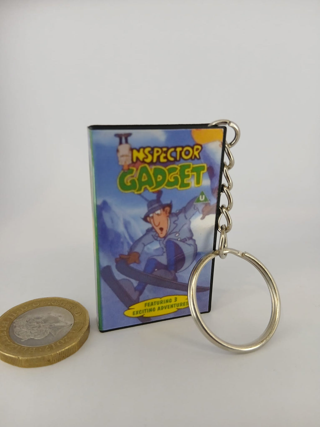 Inspector Gadget VHS keyring — front cover standing with coin for scale