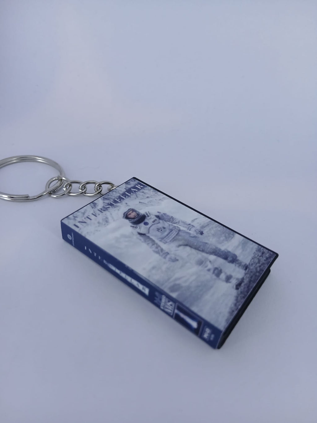 Interstellar VHS keyring — front cover flat lay angled