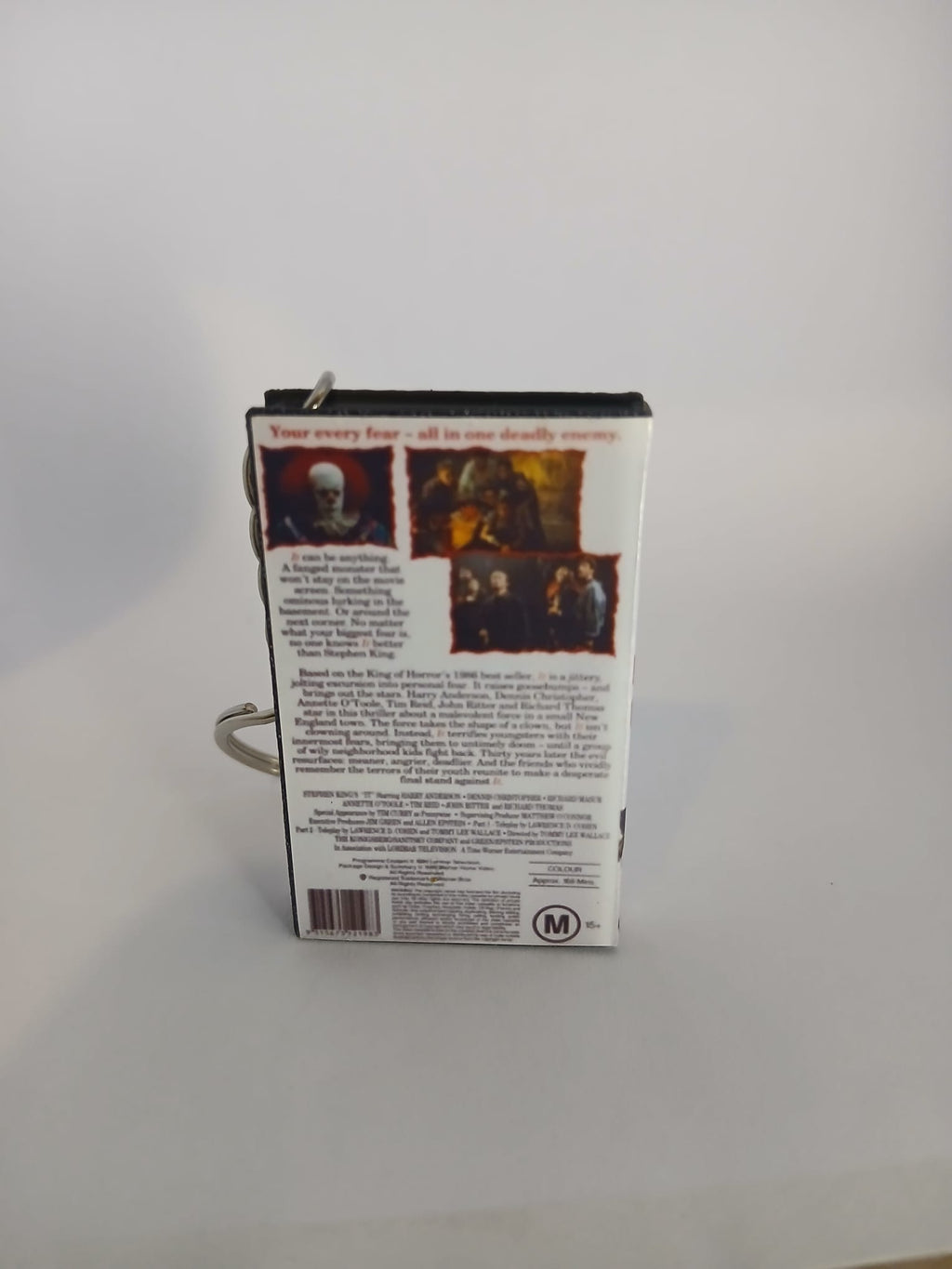Stephen King's IT VHS keyring — spine view standing