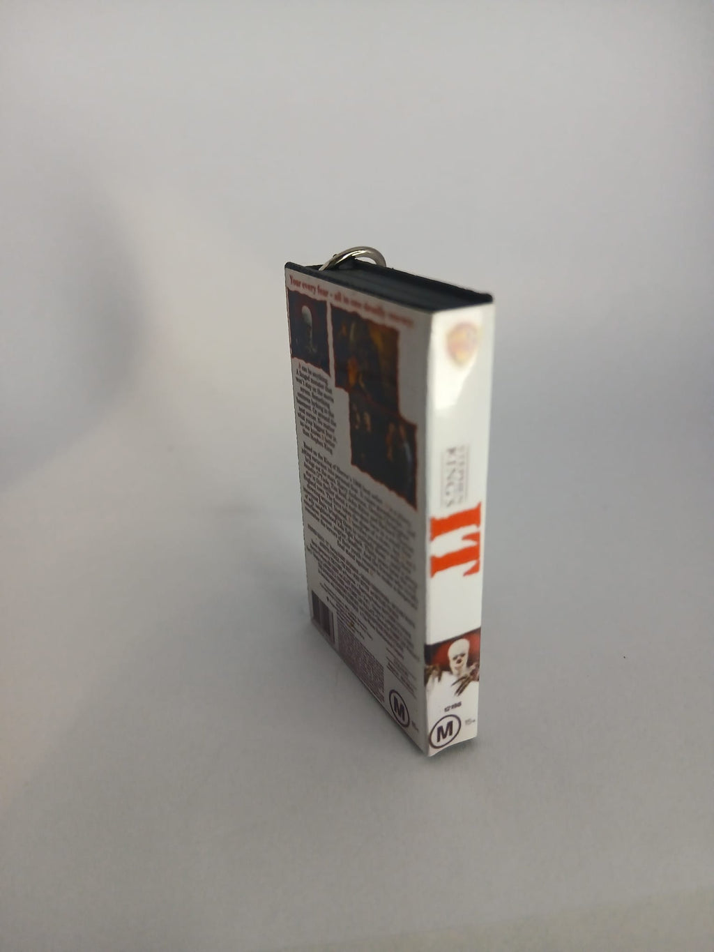Stephen King's IT VHS keyring — front cover flat lay angled
