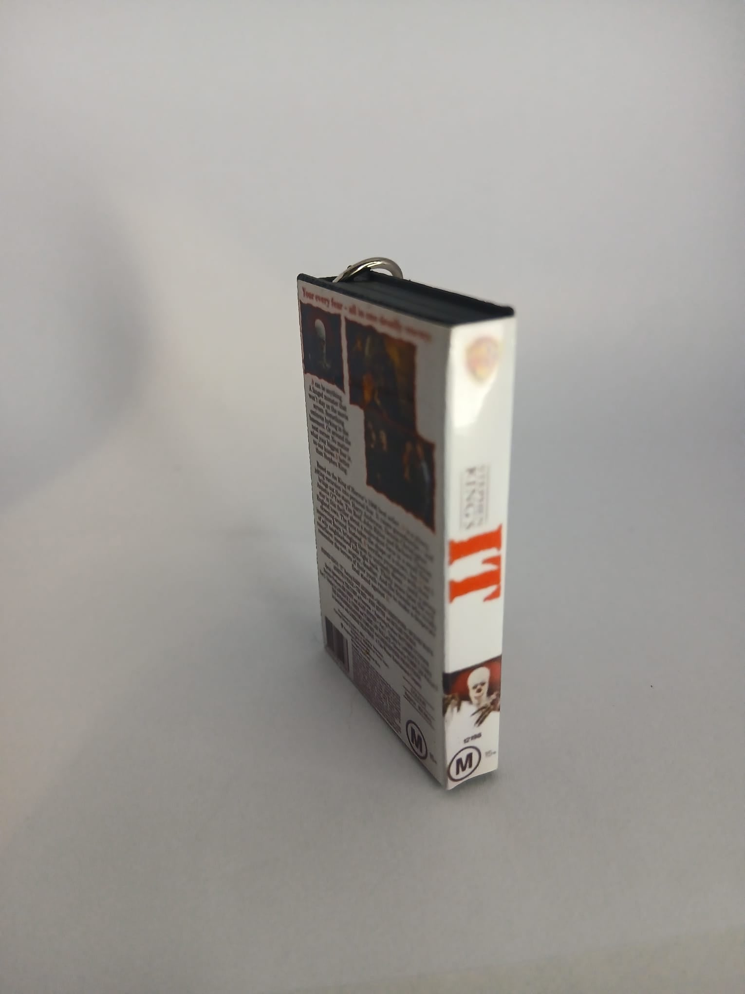 Stephen King's IT VHS keyring — front cover flat lay angled