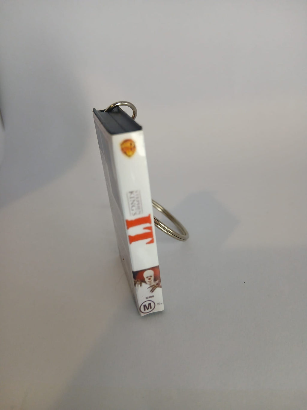 Stephen King's IT VHS keyring — front cover standing angled