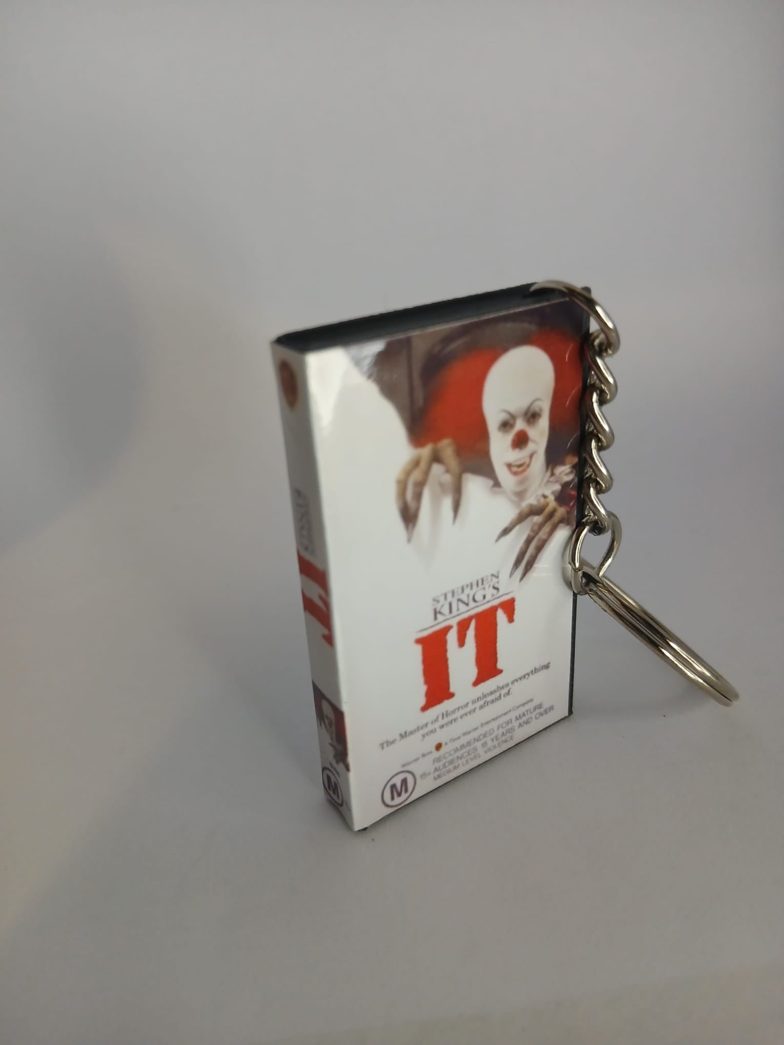 Stephen King's IT VHS keyring — front cover standing angled 3