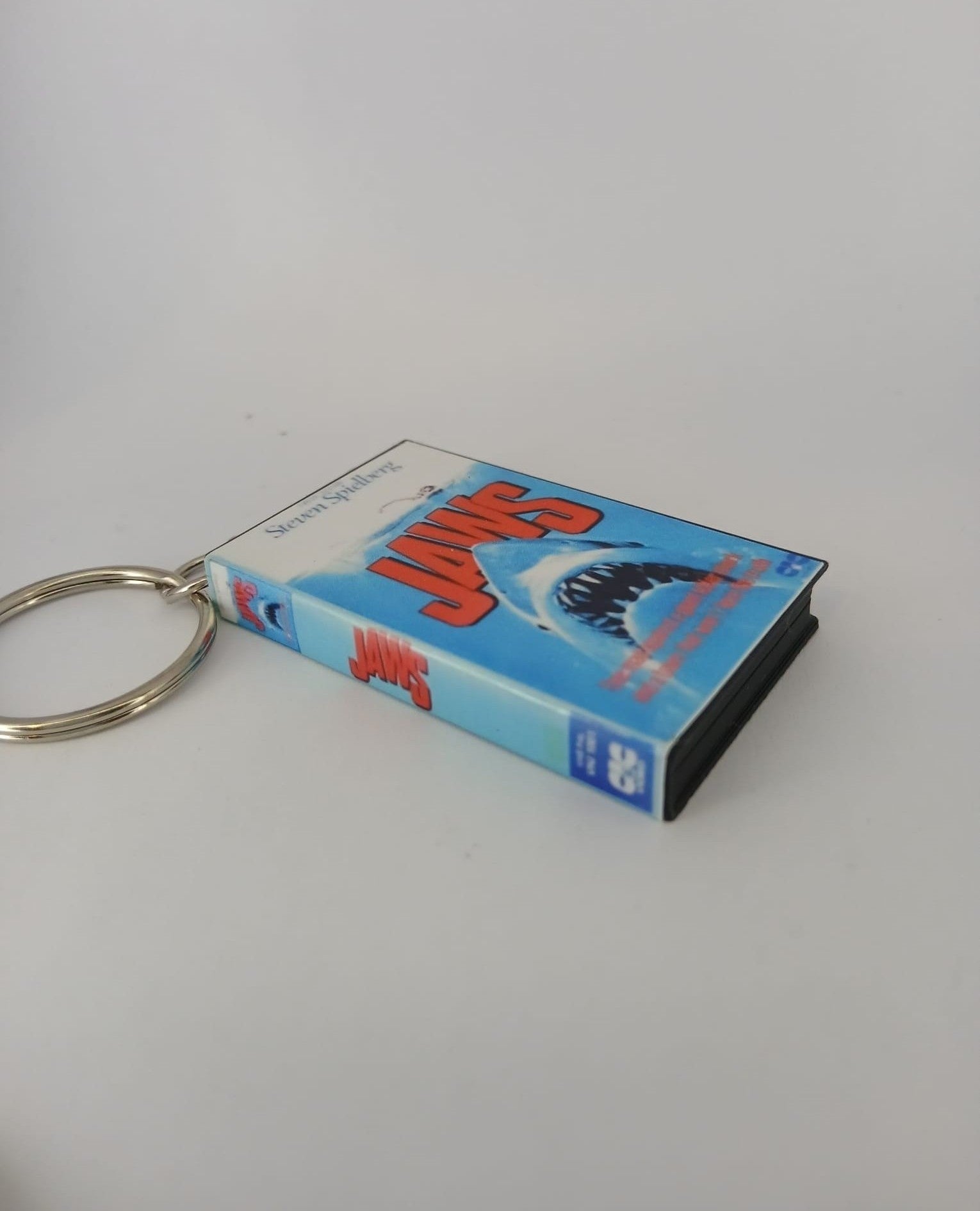 Jaws VHS keyring — front cover flat lay angled 2