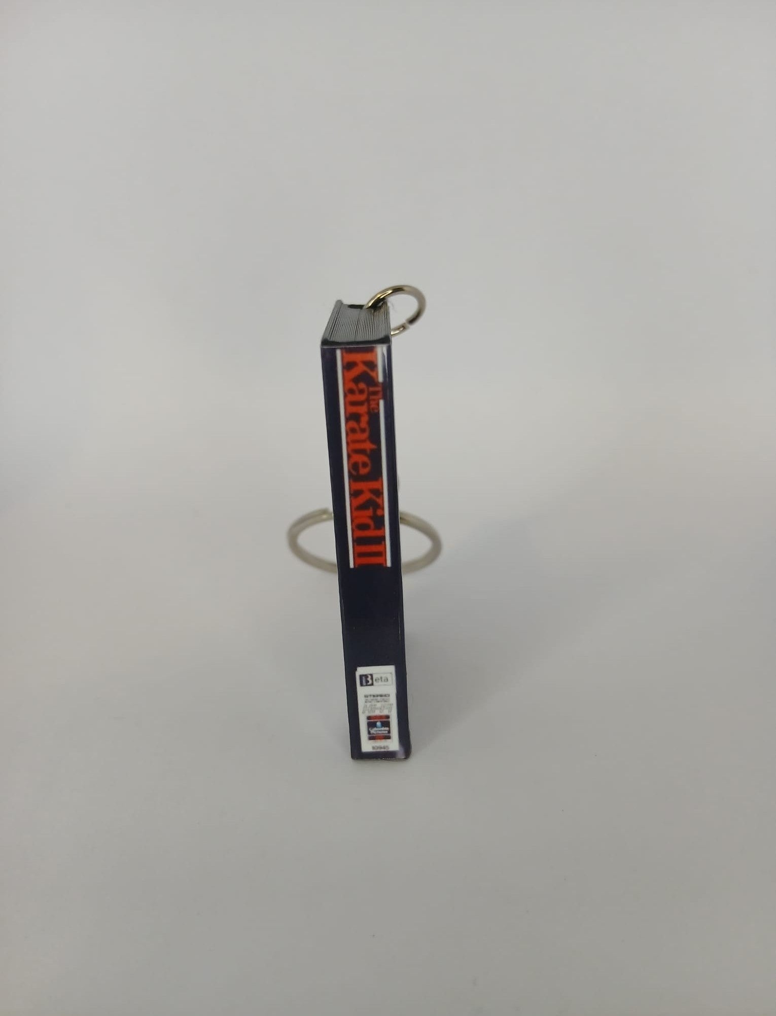 The Karate Kid Part II VHS keyring — front cover standing with coin for scale