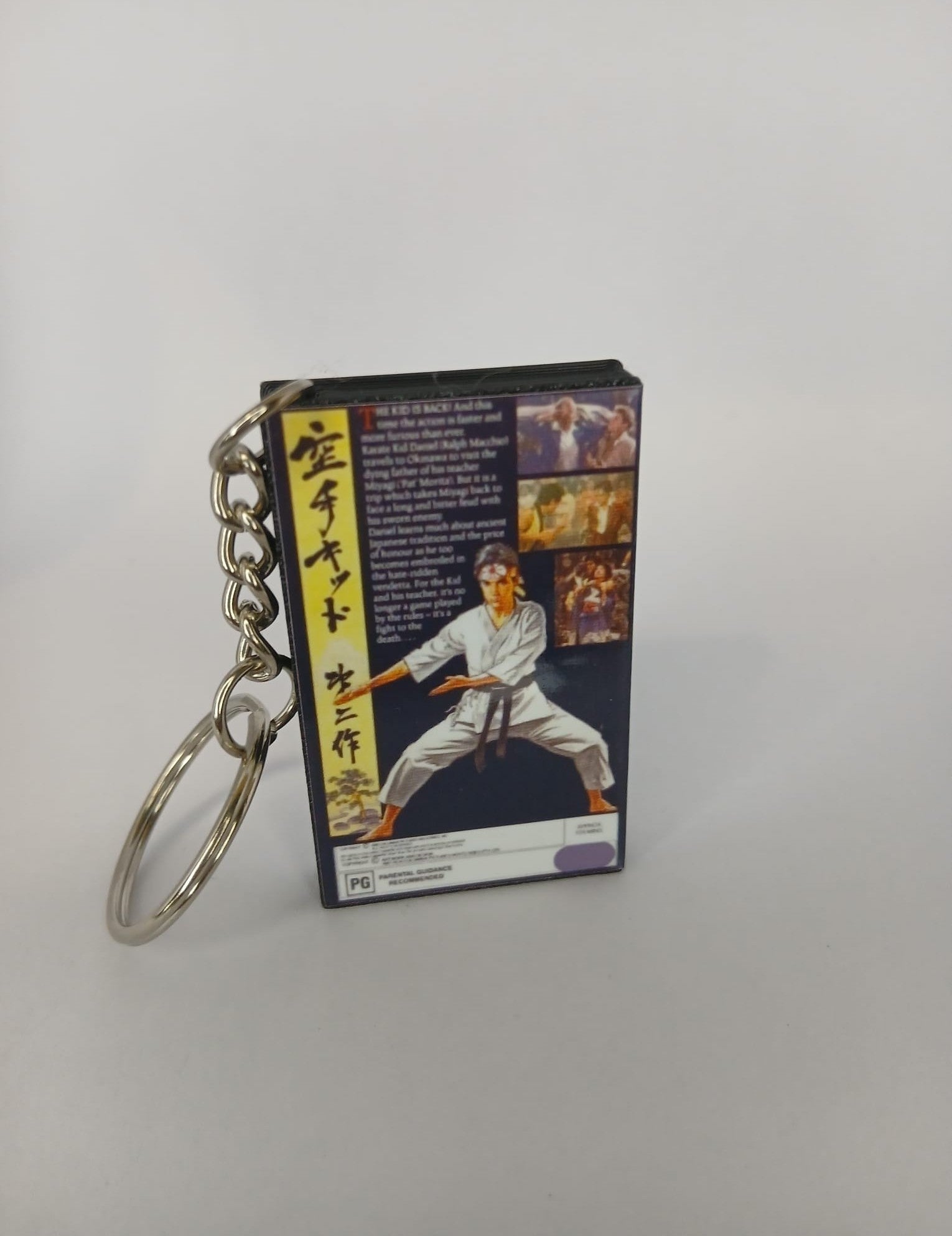 The Karate Kid Part II VHS keyring — back and spine angled view standing