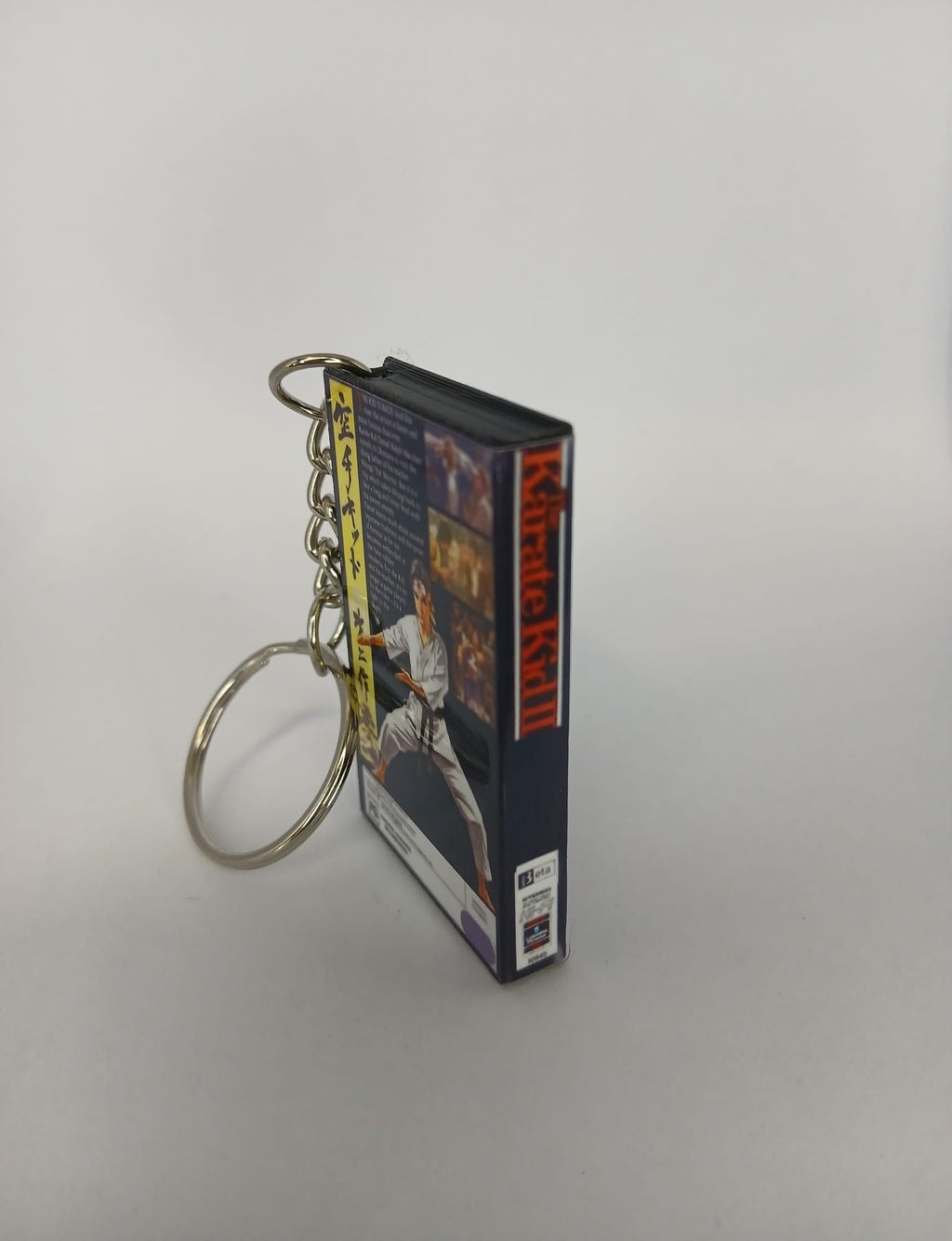 The Karate Kid Part II VHS keyring — flat lay front and back angled